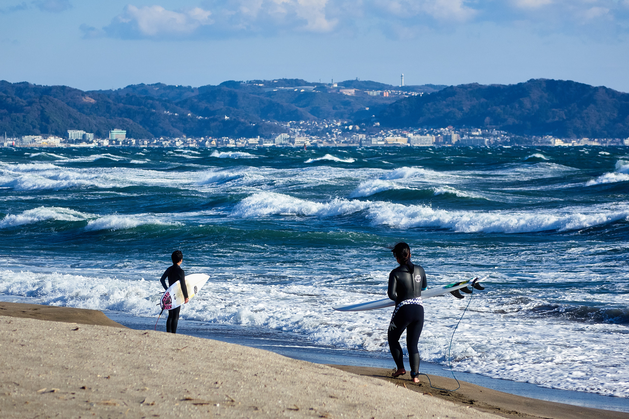 Sony Cyber-shot DSC-RX10 sample photo. Surfers at winter beach photography