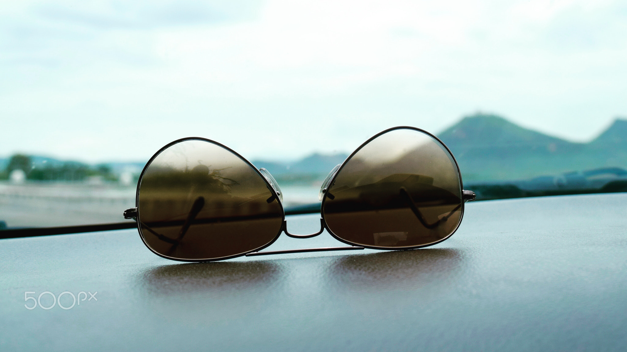 View of sunglasses on the dashboard of car
