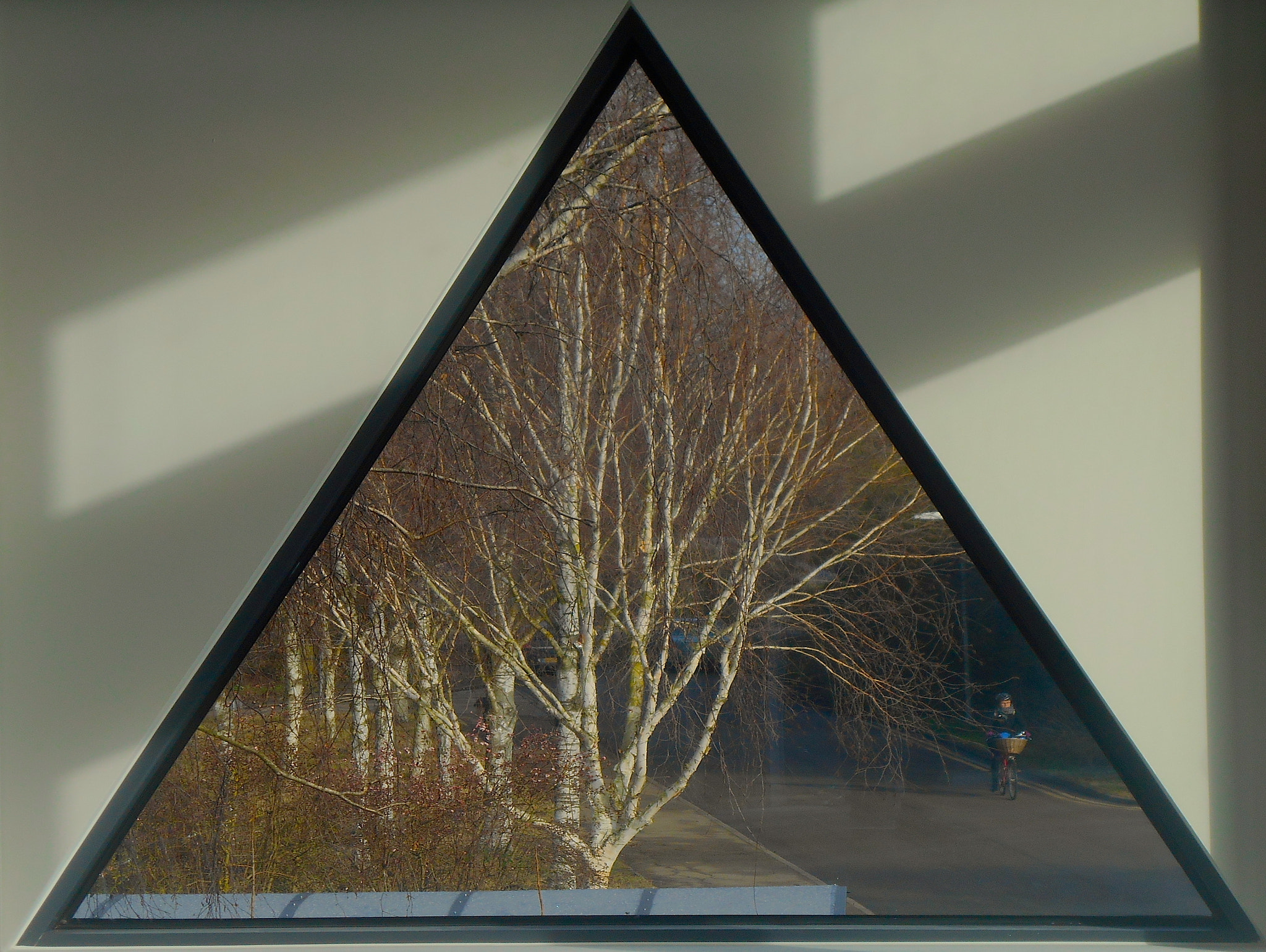 Nikon COOLPIX S3400 sample photo. Triangular window view with cyclist photography