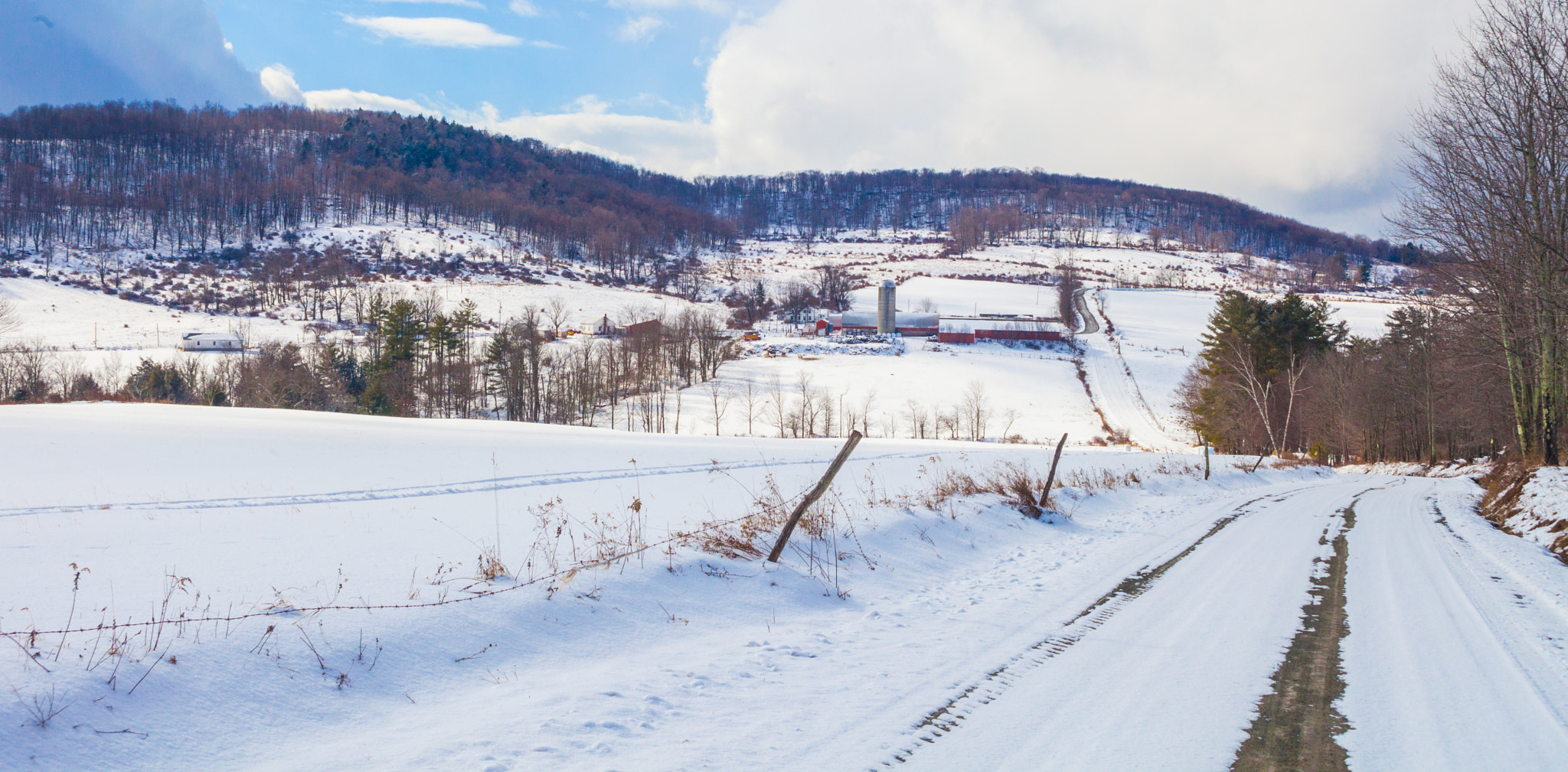 Canon EF 28-80mm f/3.5-5.6 USM sample photo. Farm on a snowy hillside photography