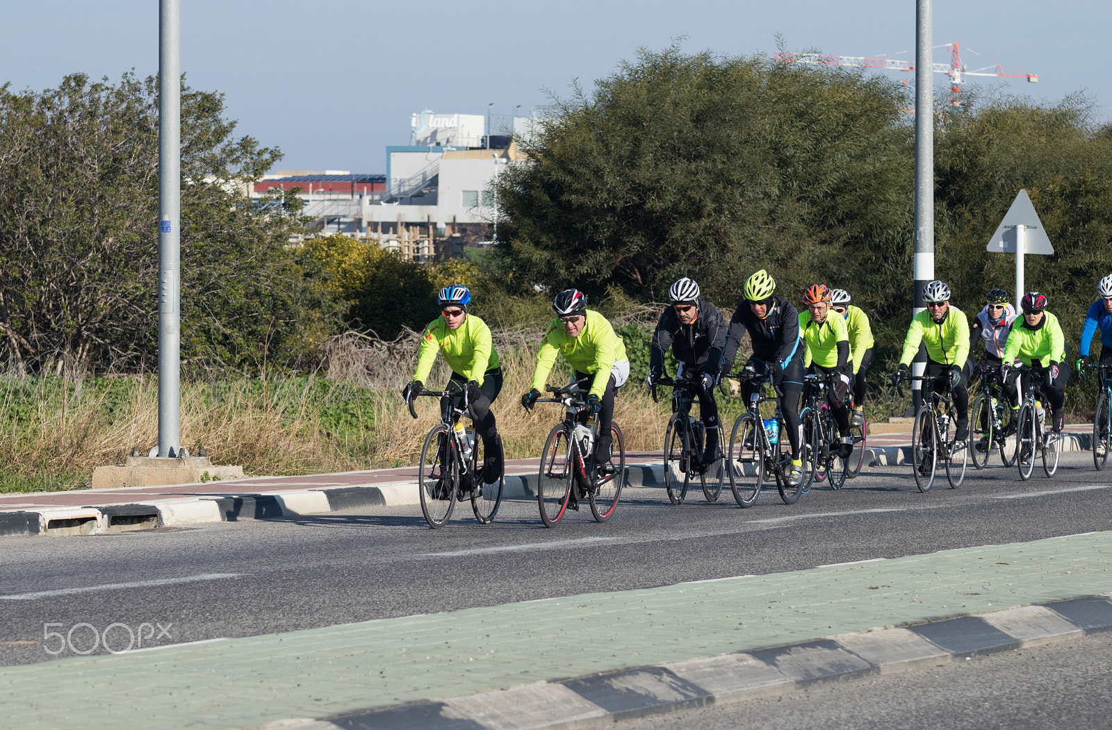 Canon EOS 80D sample photo. Group of cyclists on winter morning trains on intercity road photography