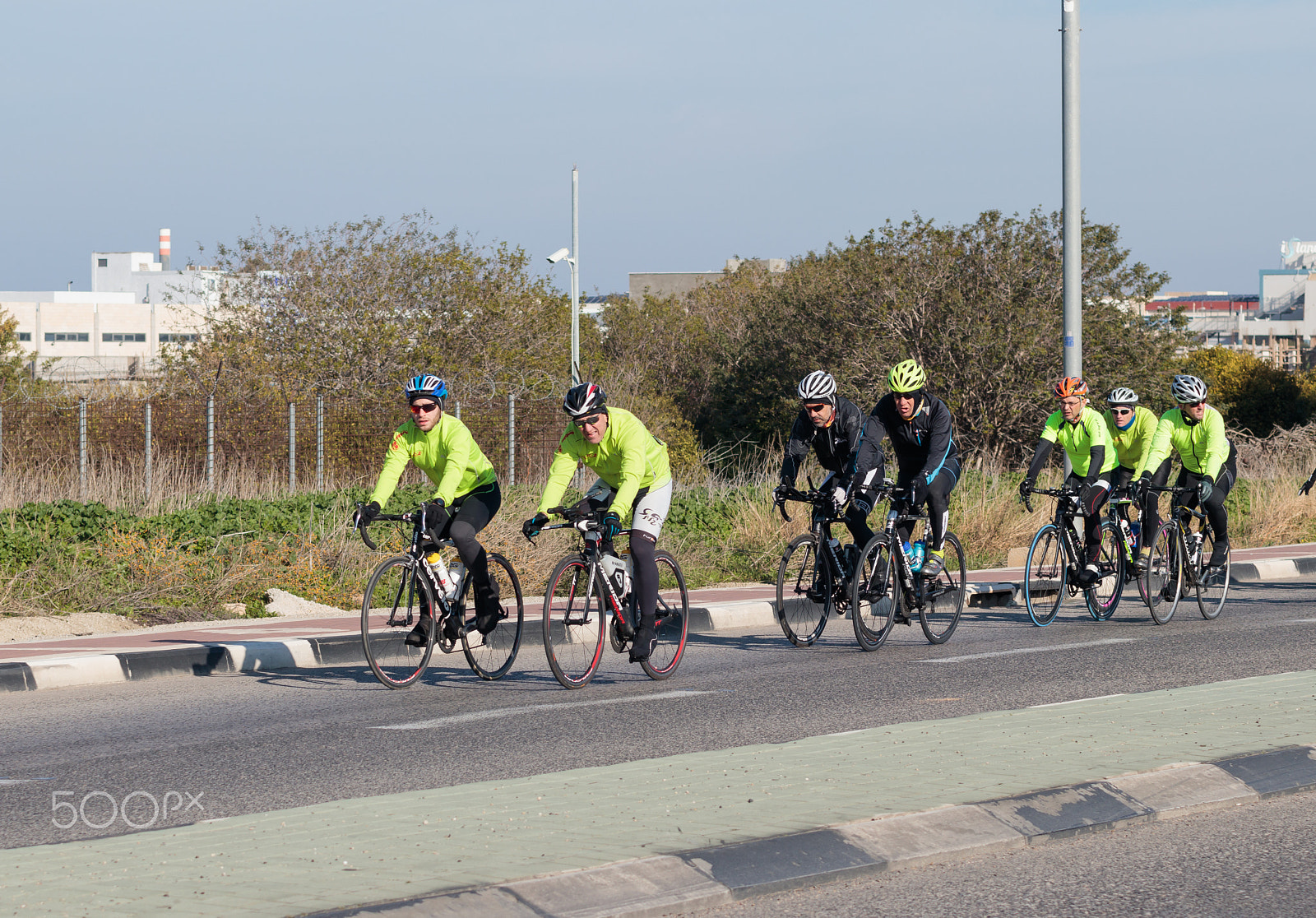 Canon EOS 80D + Sigma 50-200mm F4-5.6 DC OS HSM sample photo. Group of cyclists on winter morning trains on intercity road photography