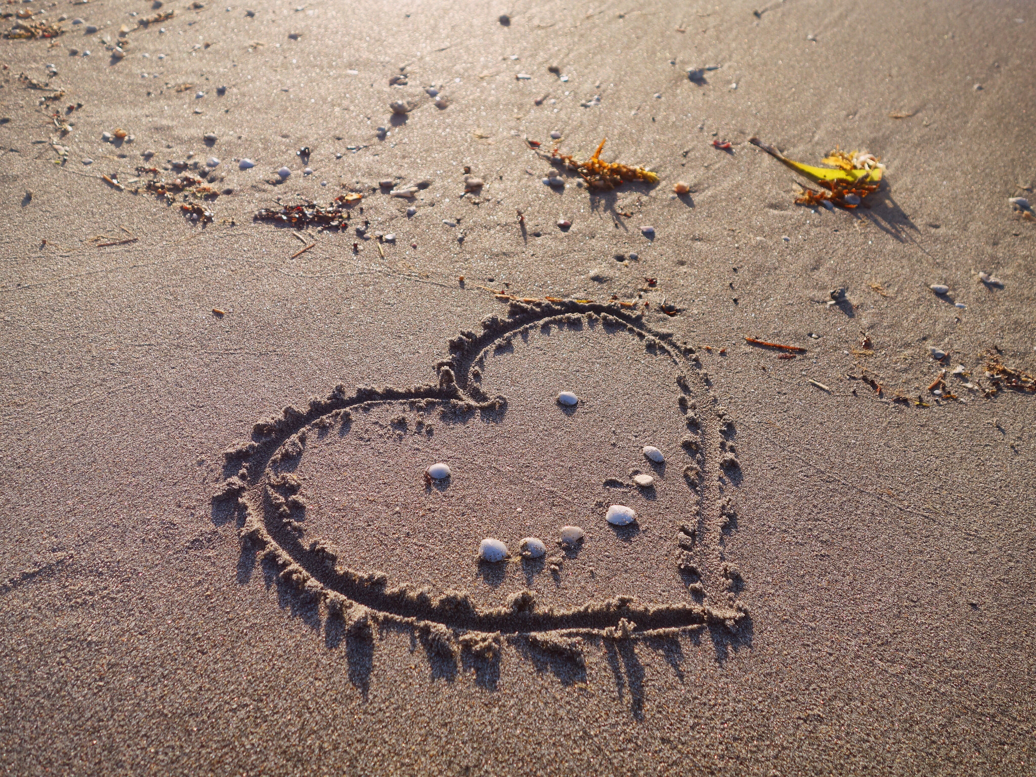 Sony 28-100mm F1.8-4.9 sample photo. Love drawn on the sand photography