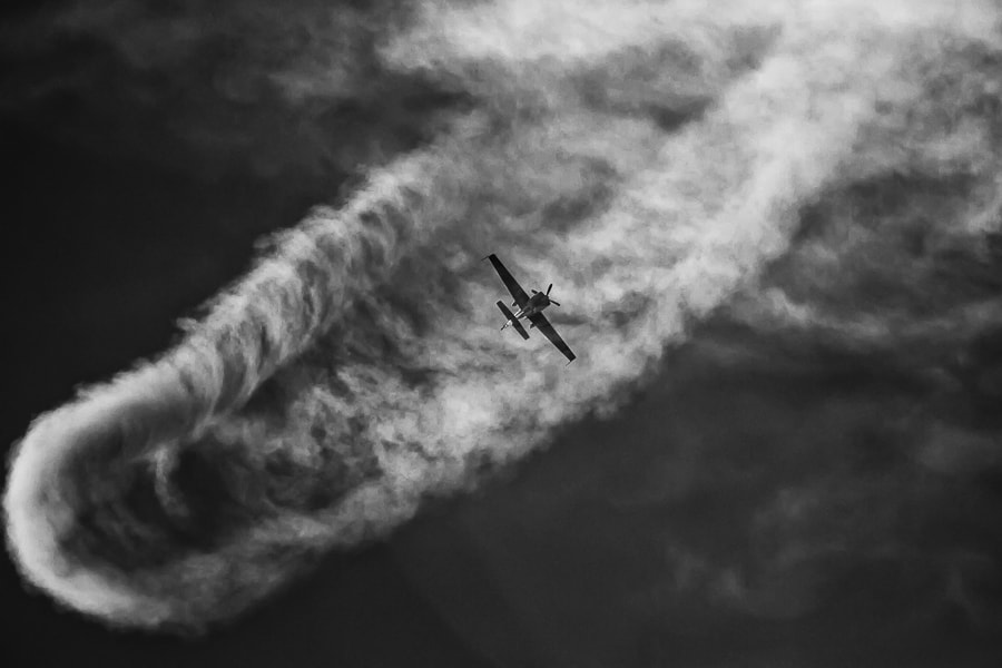 Canon EF-S 55-250mm F4-5.6 IS sample photo. A plane flying in its smoke photography