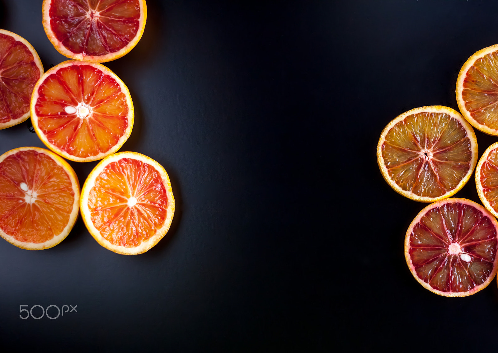 Canon EOS 500D (EOS Rebel T1i / EOS Kiss X3) + Canon EF 40mm F2.8 STM sample photo. Red sicilian oranges sliced photography