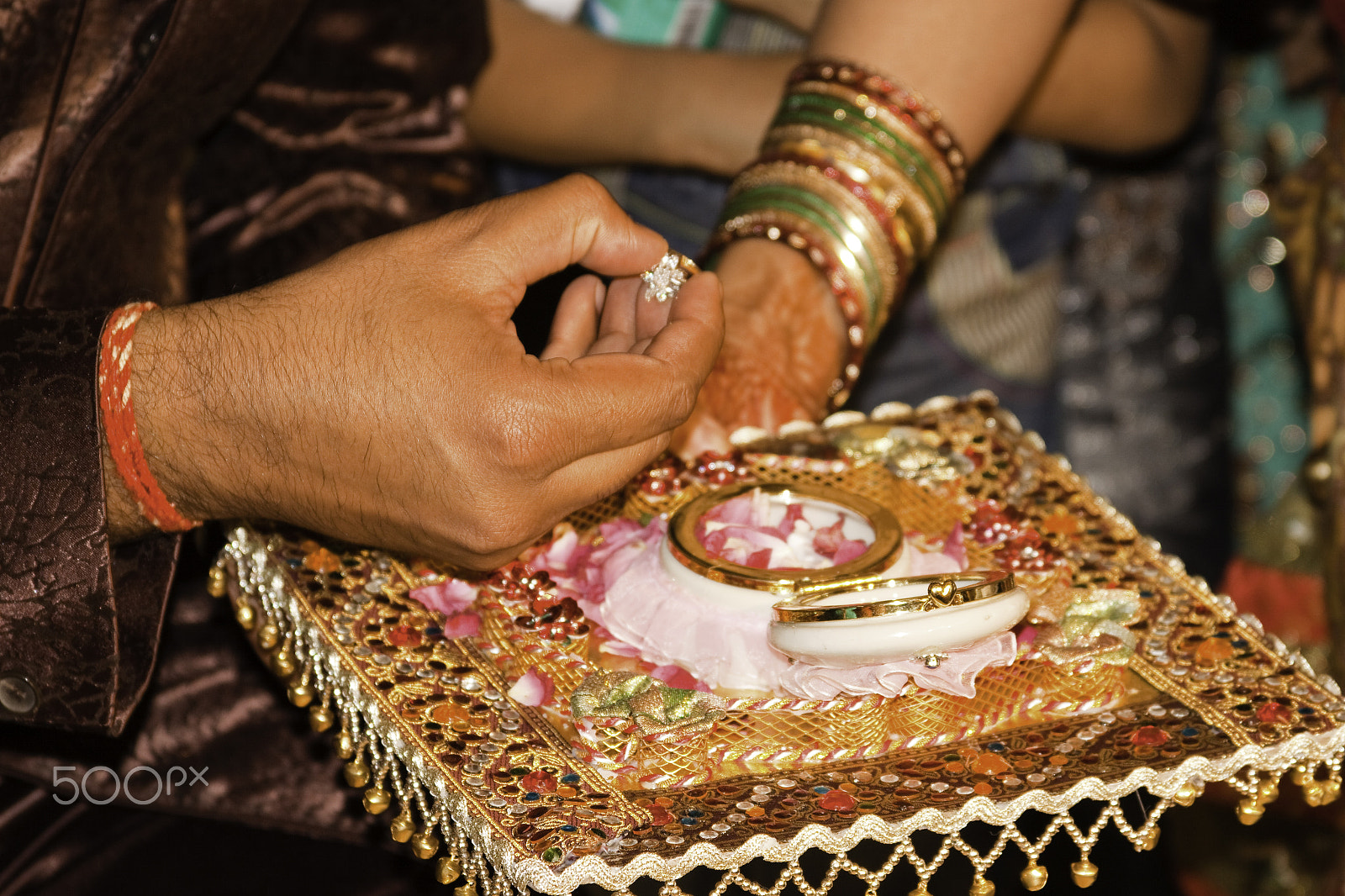 Canon EF 28-135mm F3.5-5.6 IS USM sample photo. Man taking an engagement ring out of a decorated enclosure and g photography