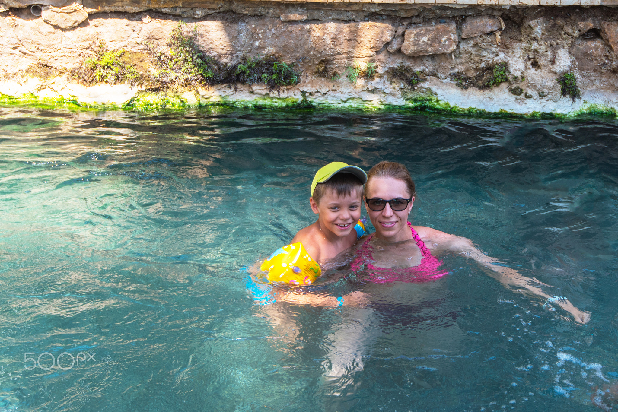 woman and her son in Cleopatra pool
