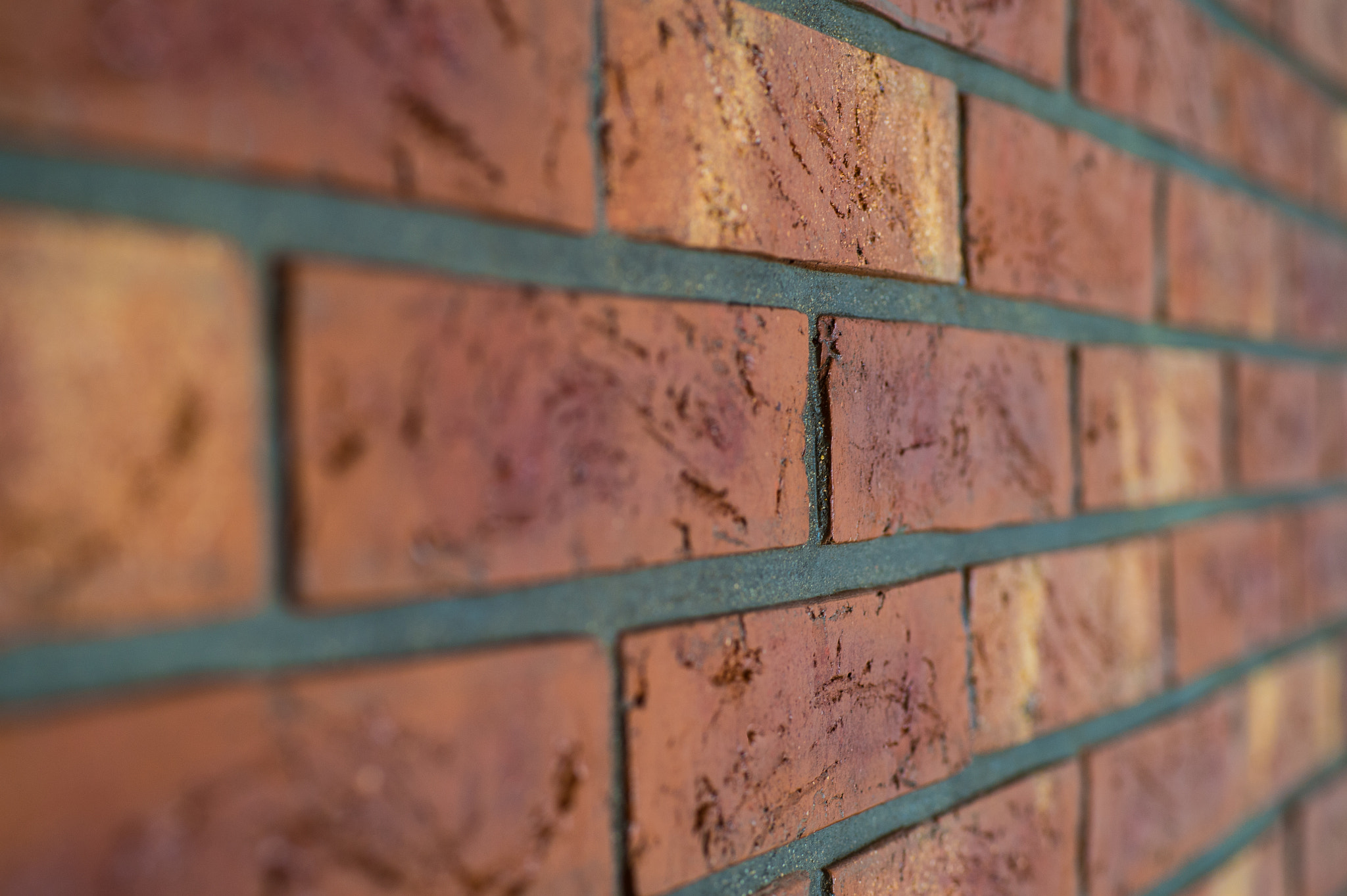 Nikon D4S + Sigma 70mm F2.8 EX DG Macro sample photo. Interior brick wall close up with shallow depth of field photography