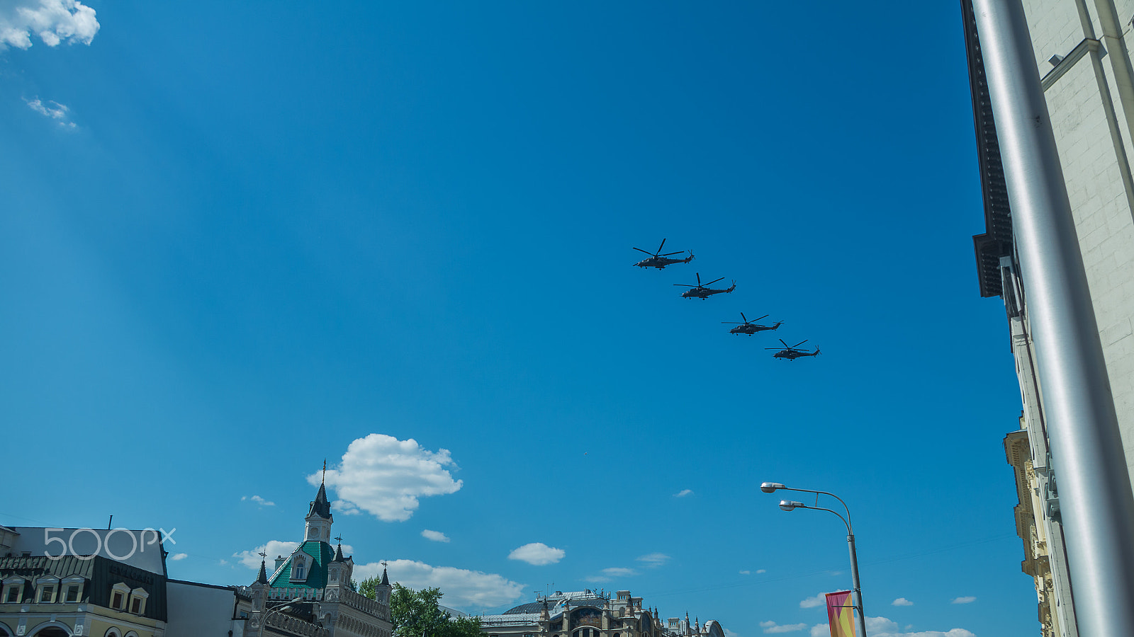 Pentax K-5 II sample photo. Four combat helicopters flying over the city photography