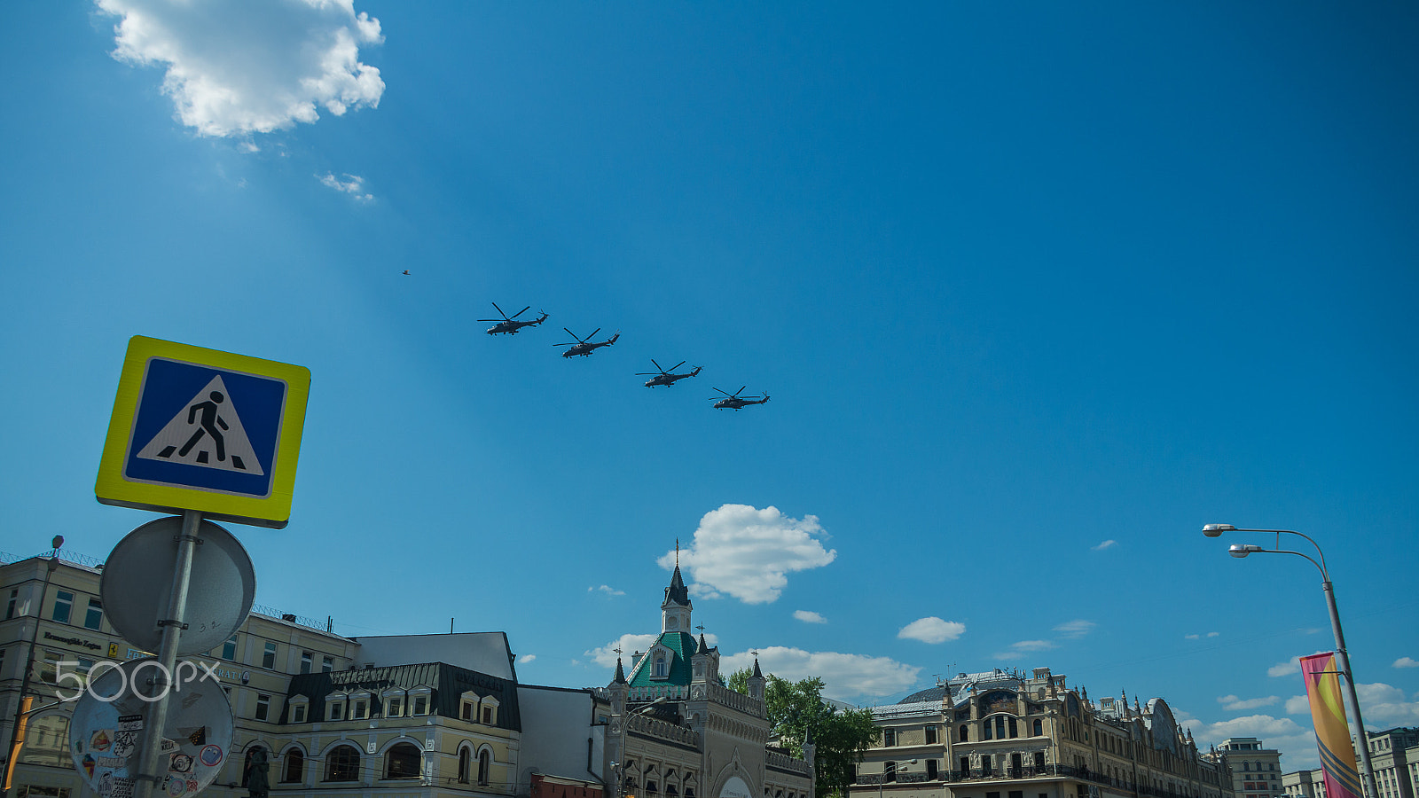 Pentax K-5 II sample photo. Four combat helicopters flying over the city photography