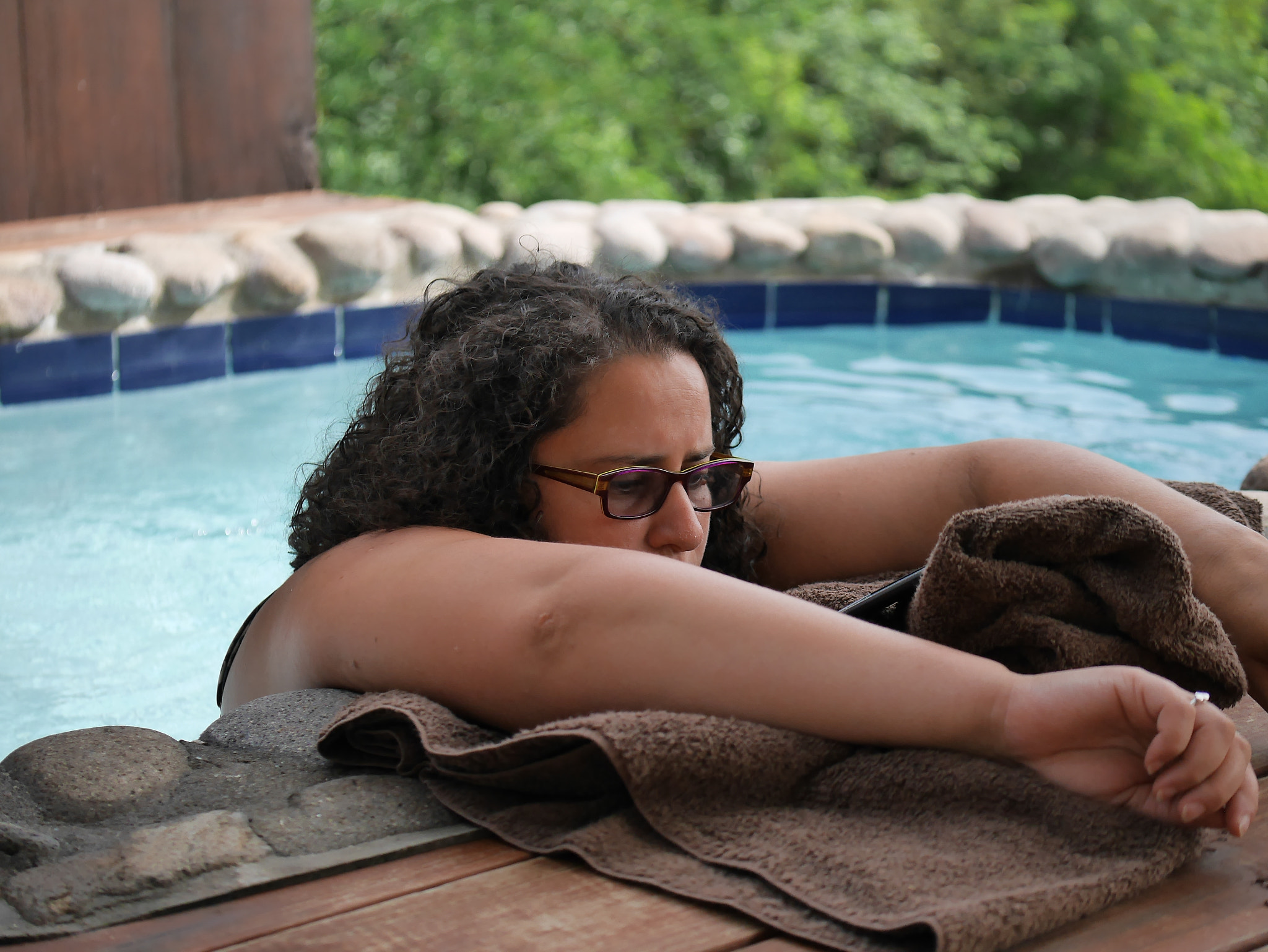 Panasonic Lumix G X Vario 35-100mm F2.8 OIS sample photo. Reading kindle in the pool photography