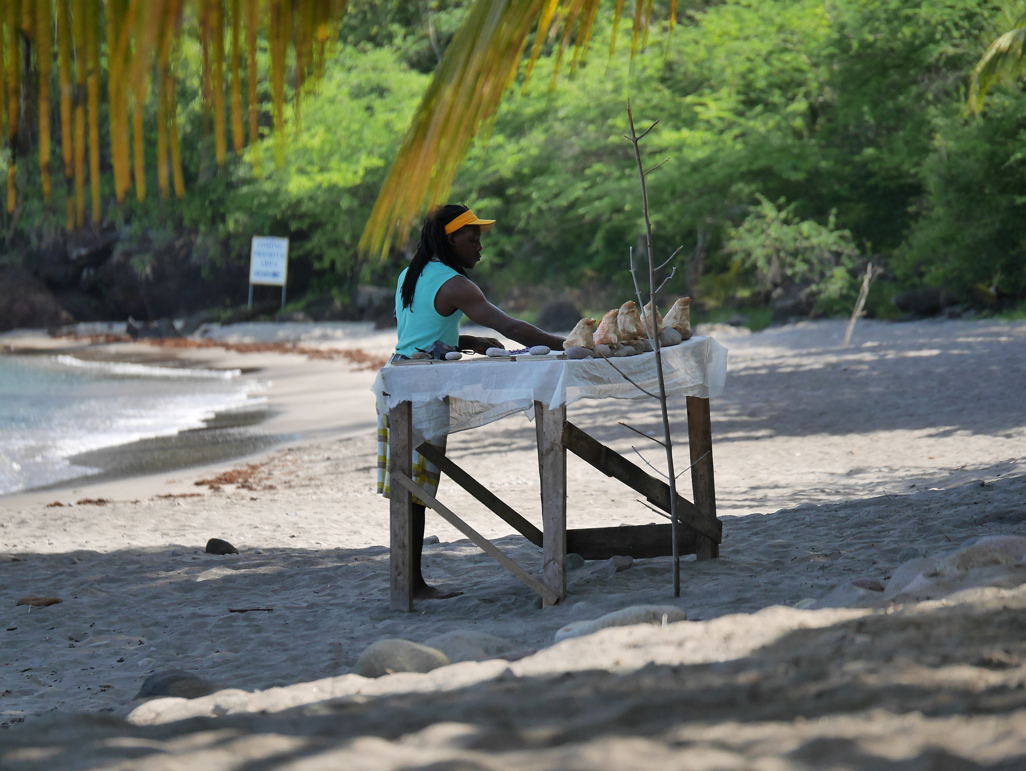 Panasonic Lumix G X Vario 35-100mm F2.8 OIS sample photo. Beach vendor setting up for the day photography