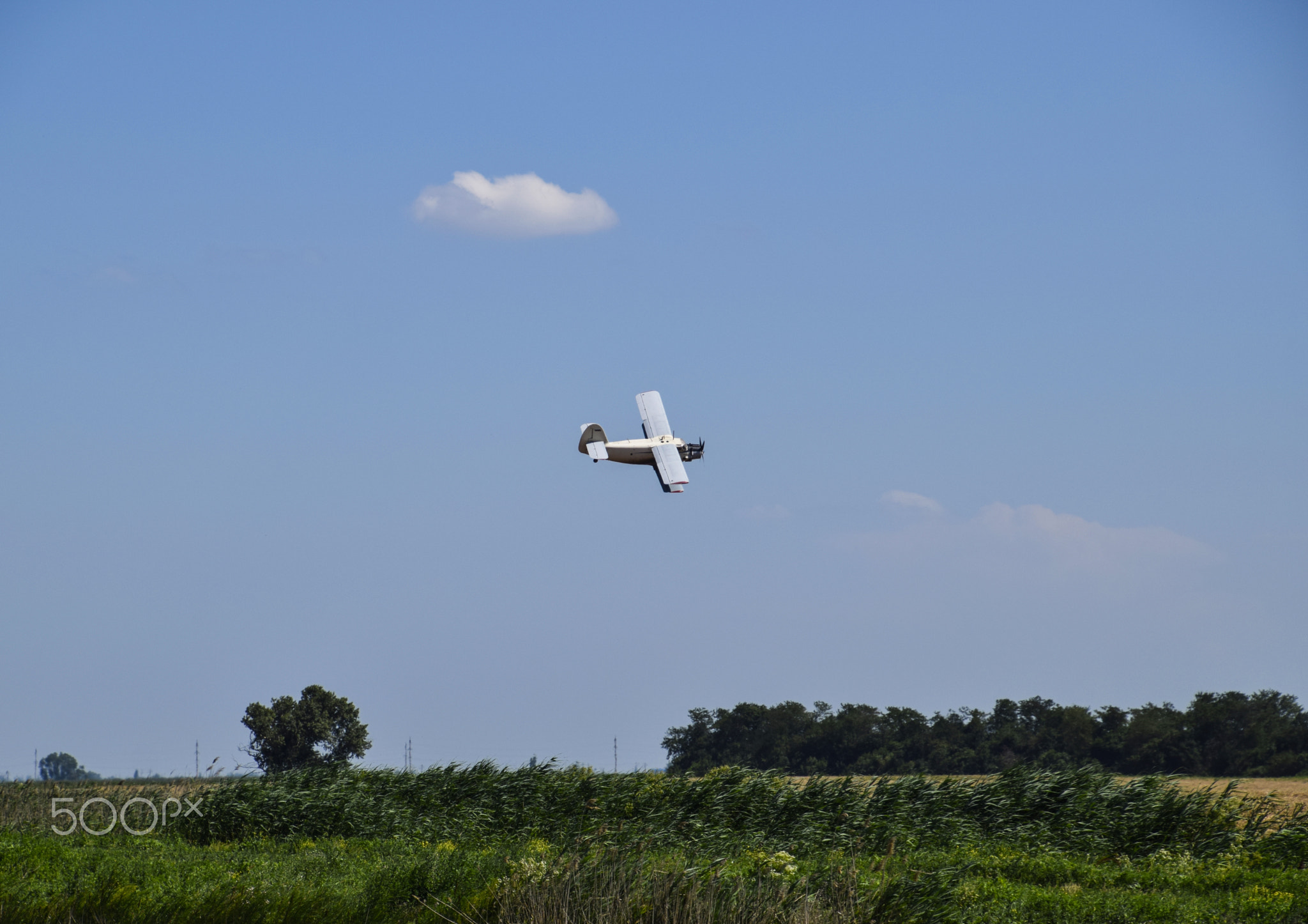 The spraying of fertilizers and pesticides on the field with the aircraft.