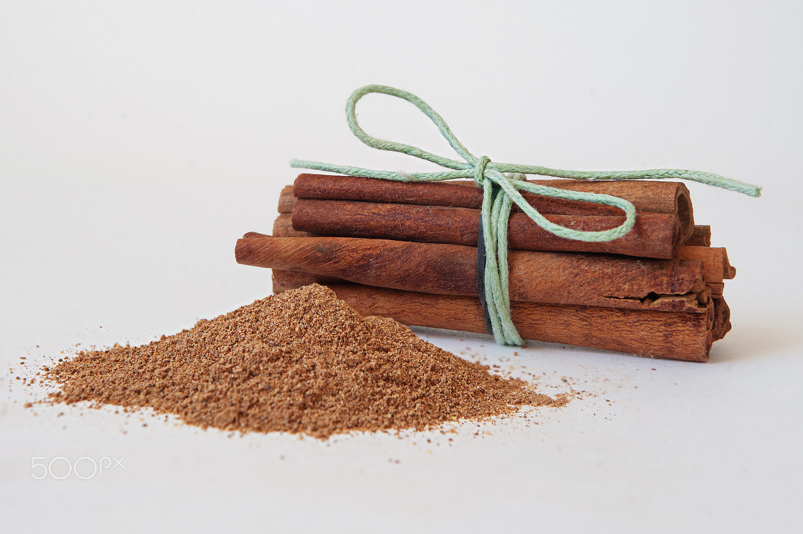 Nikon D700 + Sigma 24-70mm F2.8 EX DG Macro sample photo. Cinnamon sticks with powder on white background photography