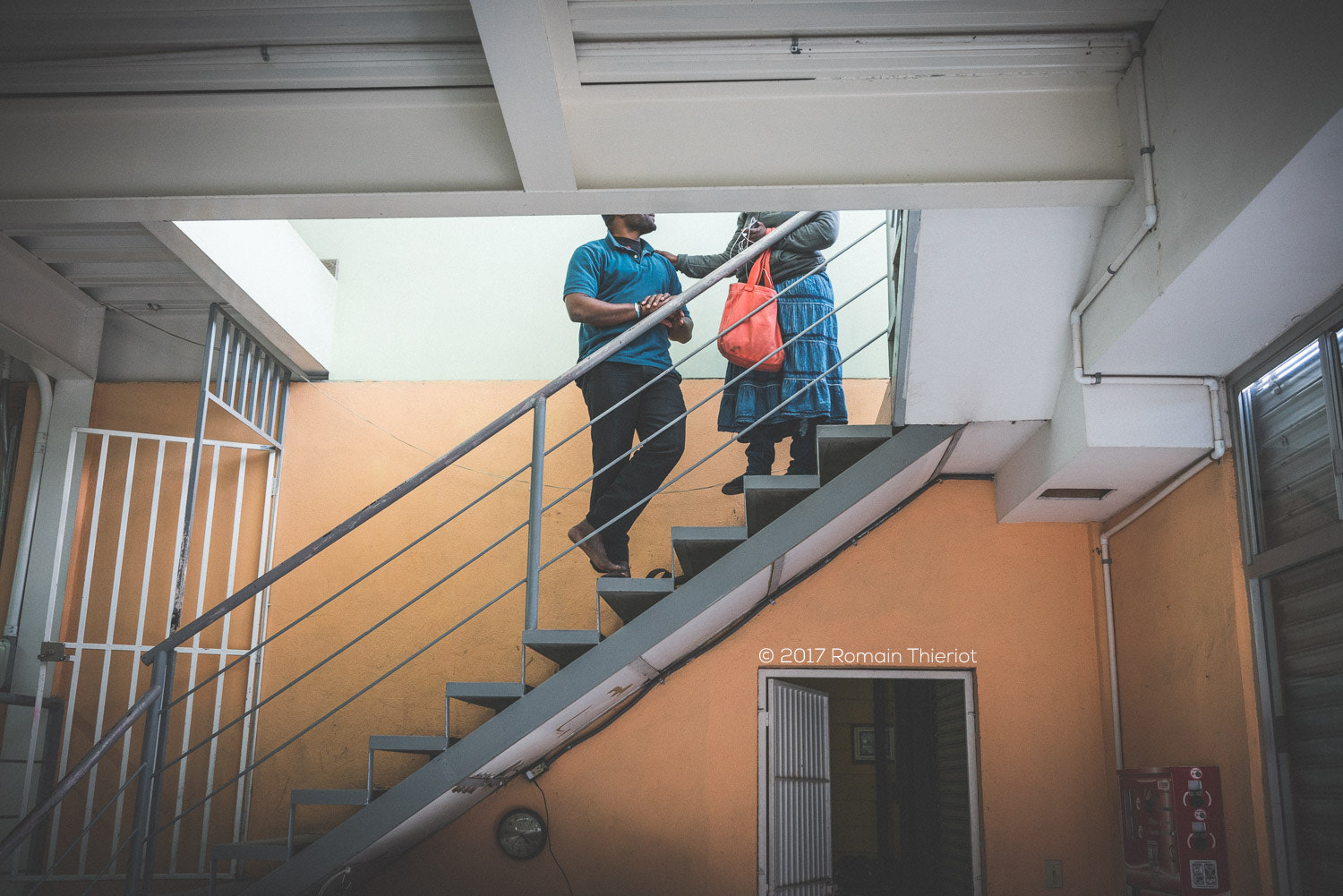 35mm F2.0 sample photo. A couple of haitian migrants in a refugee house photography