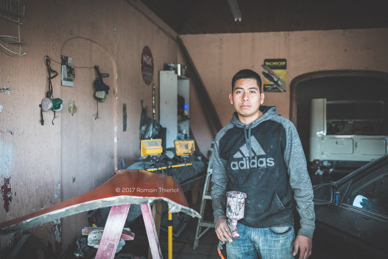 35mm F2.0 sample photo. Miguel in his car body shop photography