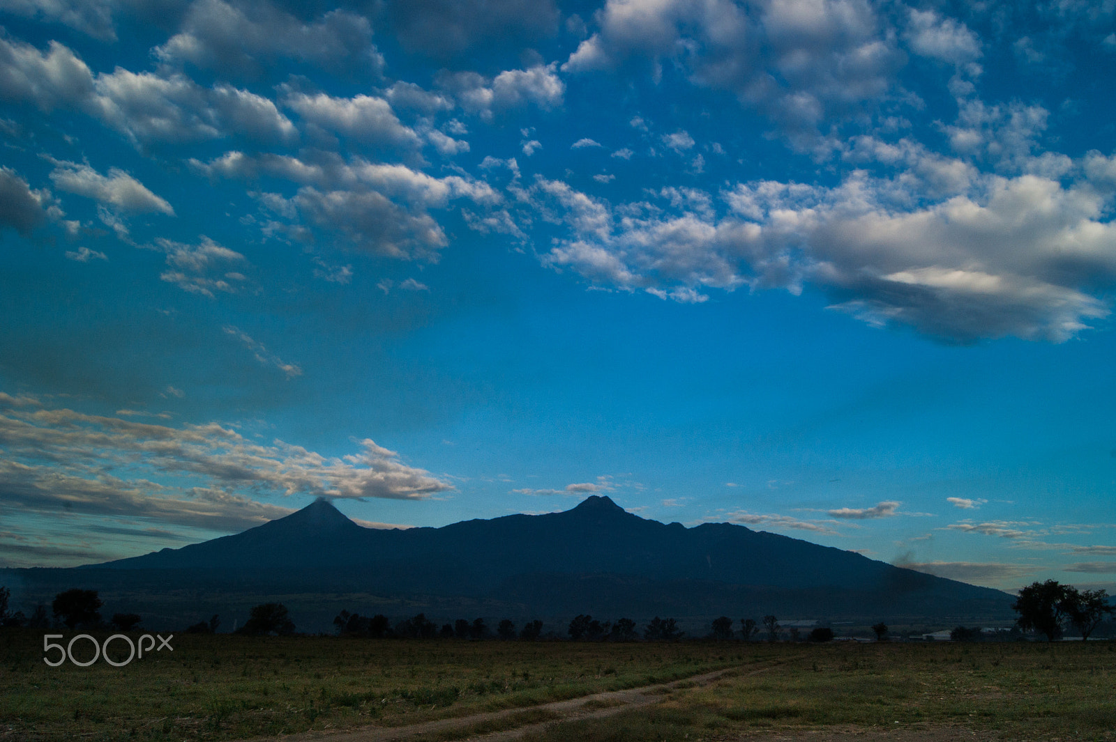 Sony Alpha DSLR-A380 + Sony DT 18-55mm F3.5-5.6 SAM sample photo. Cloudy blue sky over the volcanoes photography