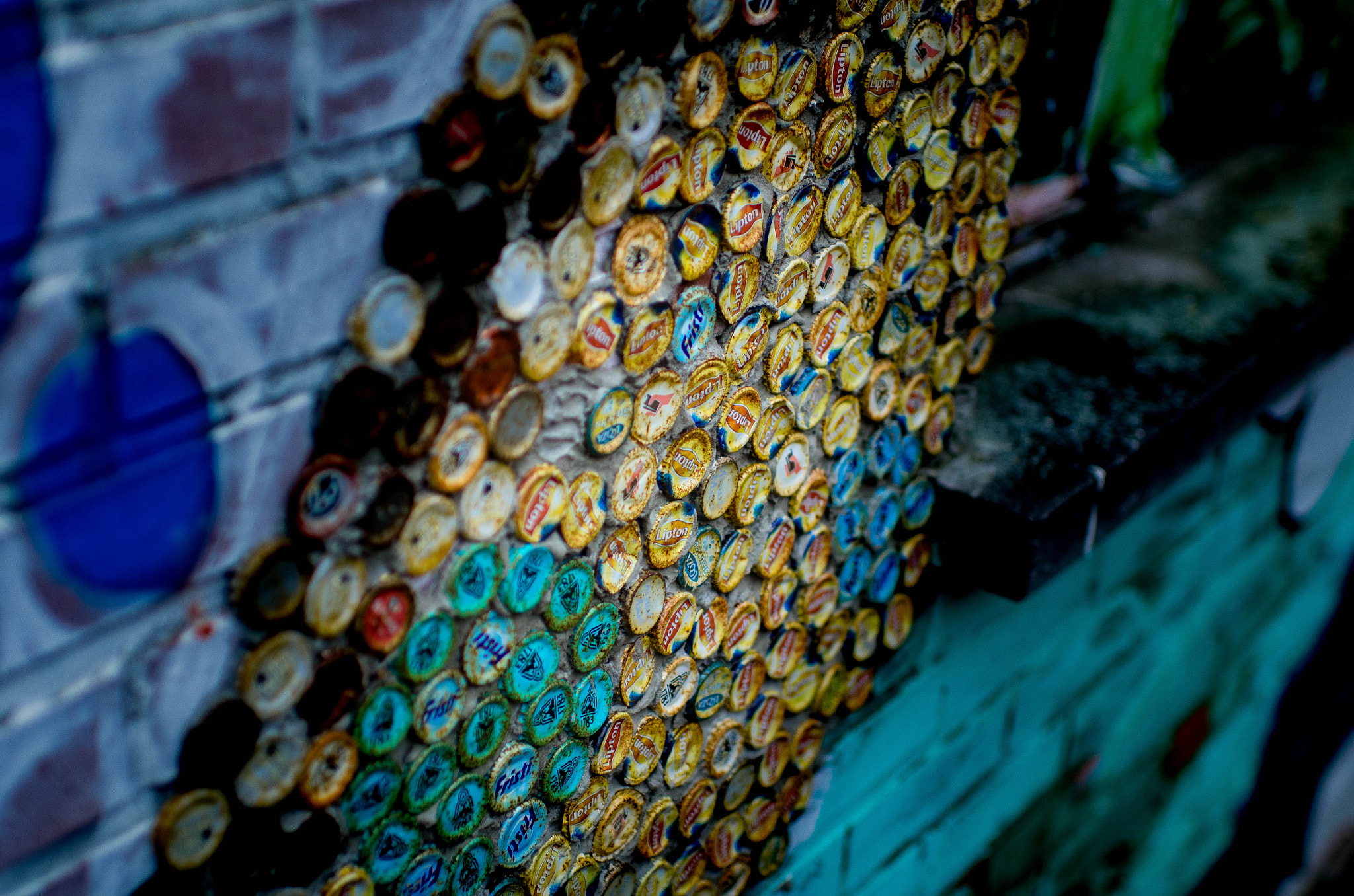 Nikon D7000 + Nikon AF-S Nikkor 35mm F1.4G sample photo. Wall of soda caps photography