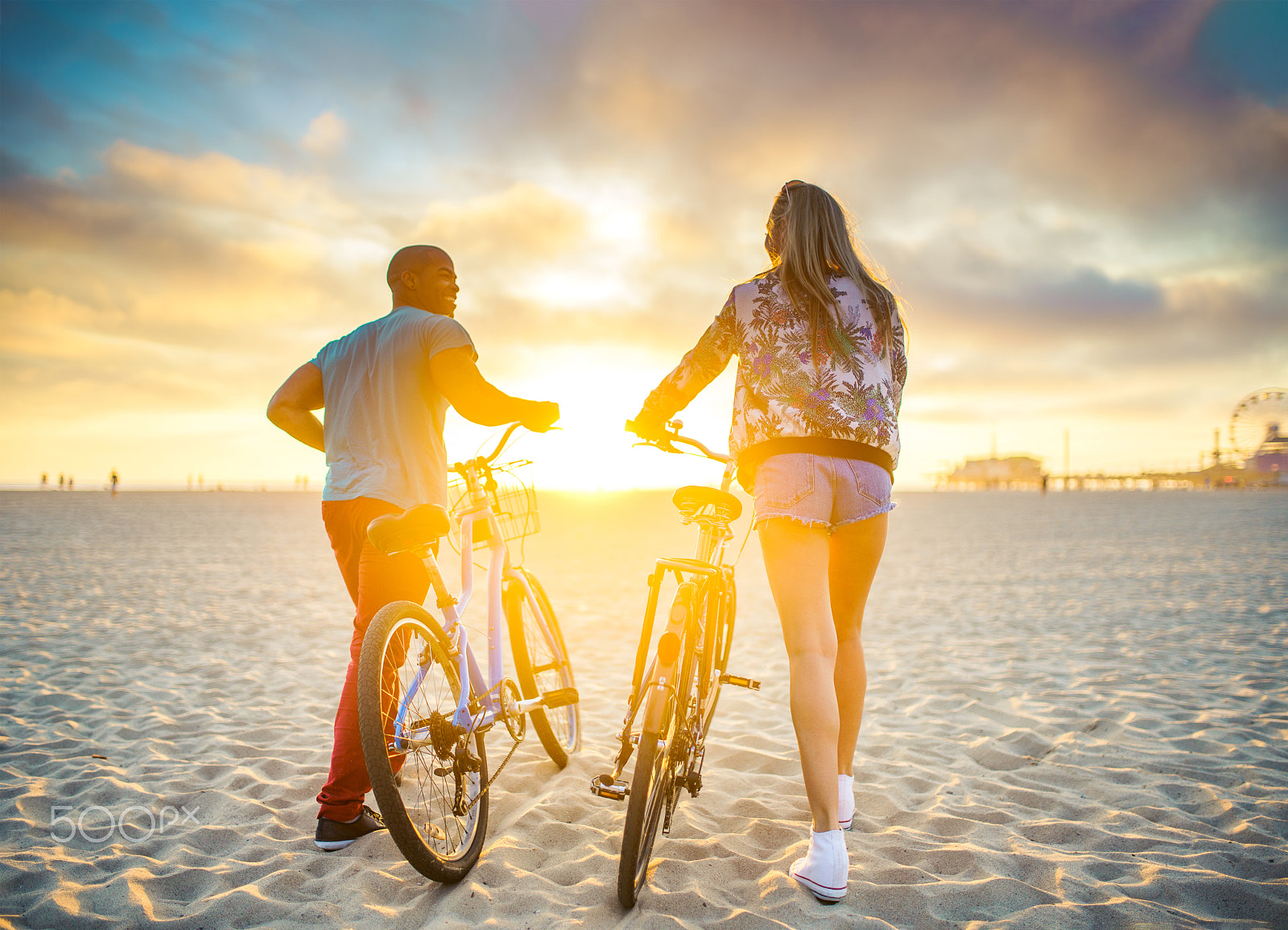 Sony a7R II + Sigma 35mm F1.4 DG HSM Art sample photo. Couple walking bikes together on beach to stunning sunset photography
