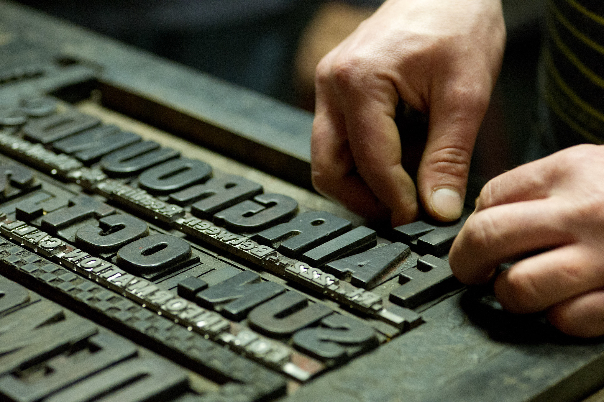 ZEISS Makro-Planar T* 100mm F2 sample photo. Hands working with print block letters photography