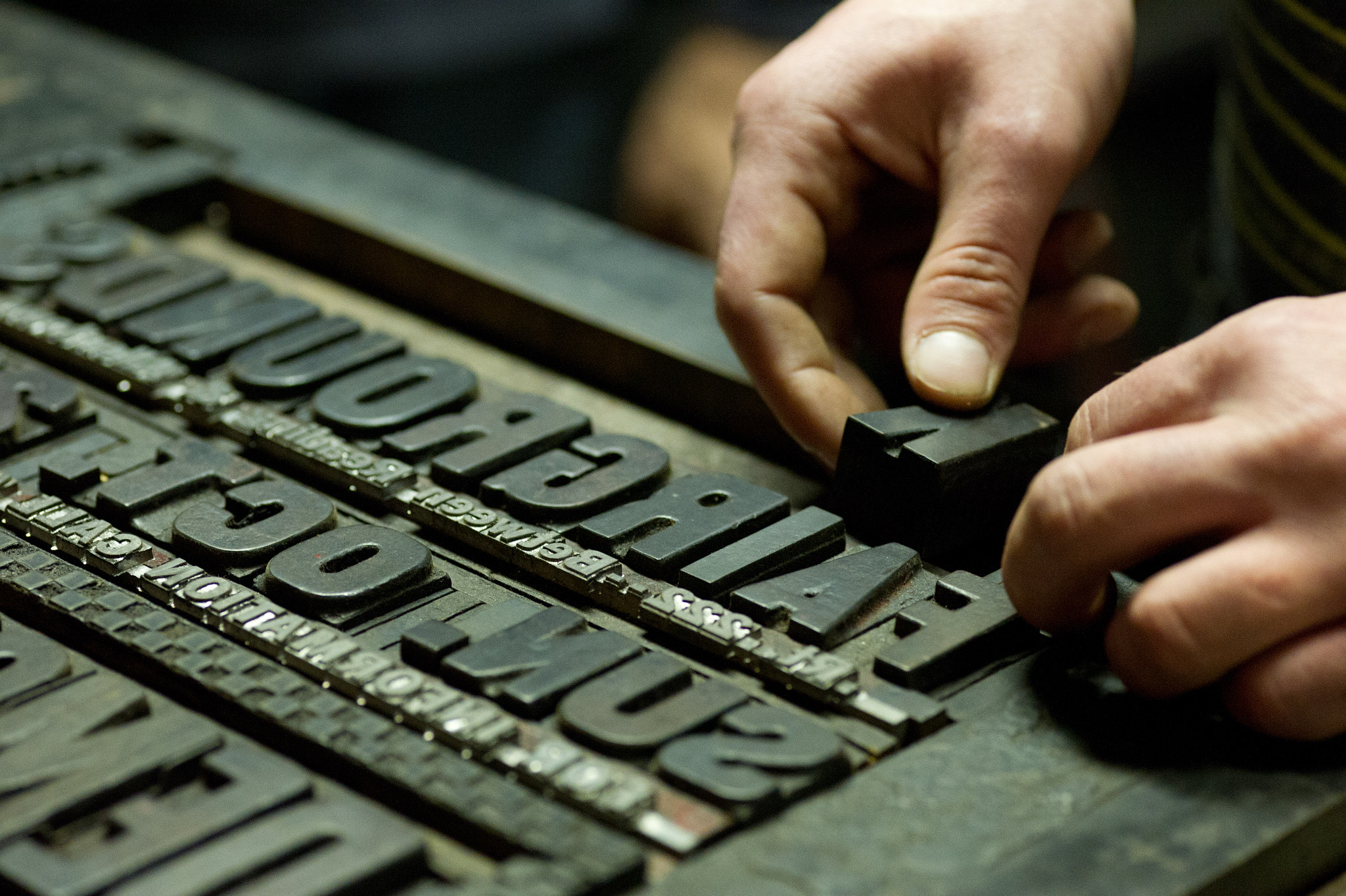 ZEISS Makro-Planar T* 100mm F2 sample photo. Hands working with print block letters photography