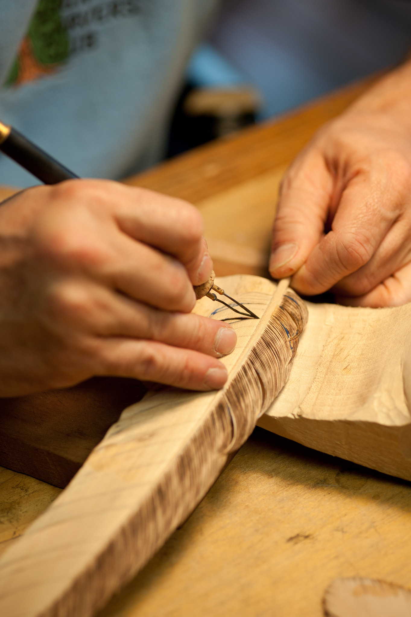 ZEISS Makro-Planar T* 100mm F2 sample photo. Hands carving a bird feather from wood photography