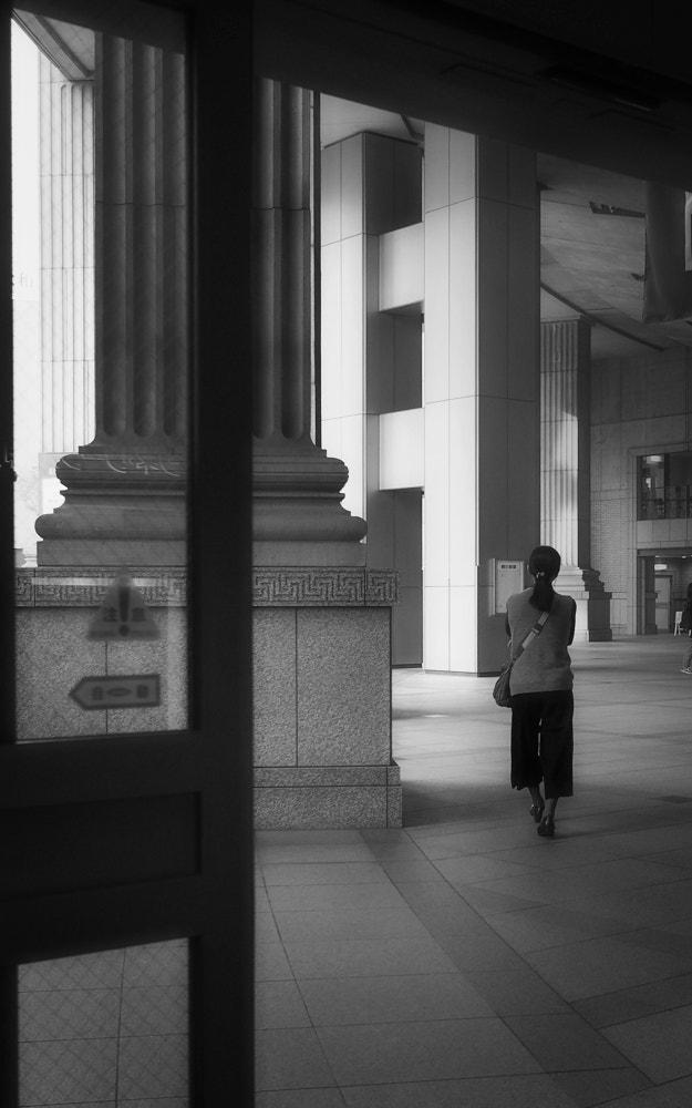 Olympus PEN E-P5 sample photo. A woman leaving photography