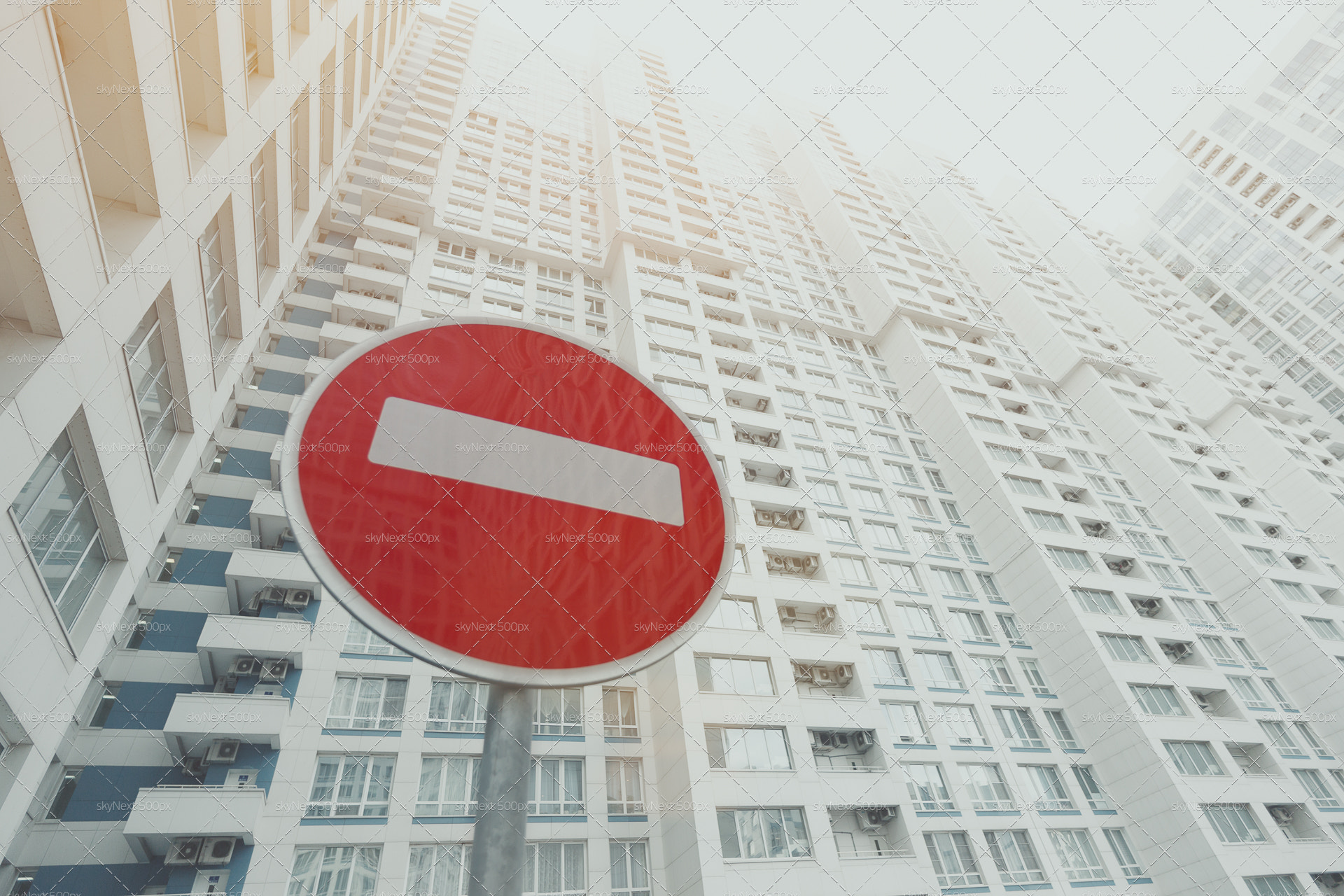 Canon EOS 6D sample photo. Contemporary white and grey skyscraper, red stop road sign below photography