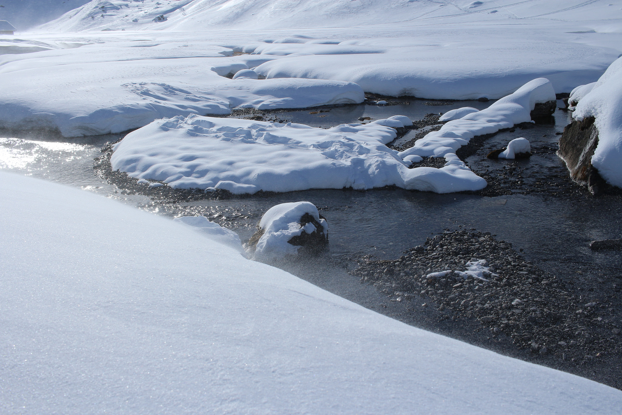 Canon EF-S 24mm F2.8 STM sample photo. Running stream in the midst of powdered snow photography