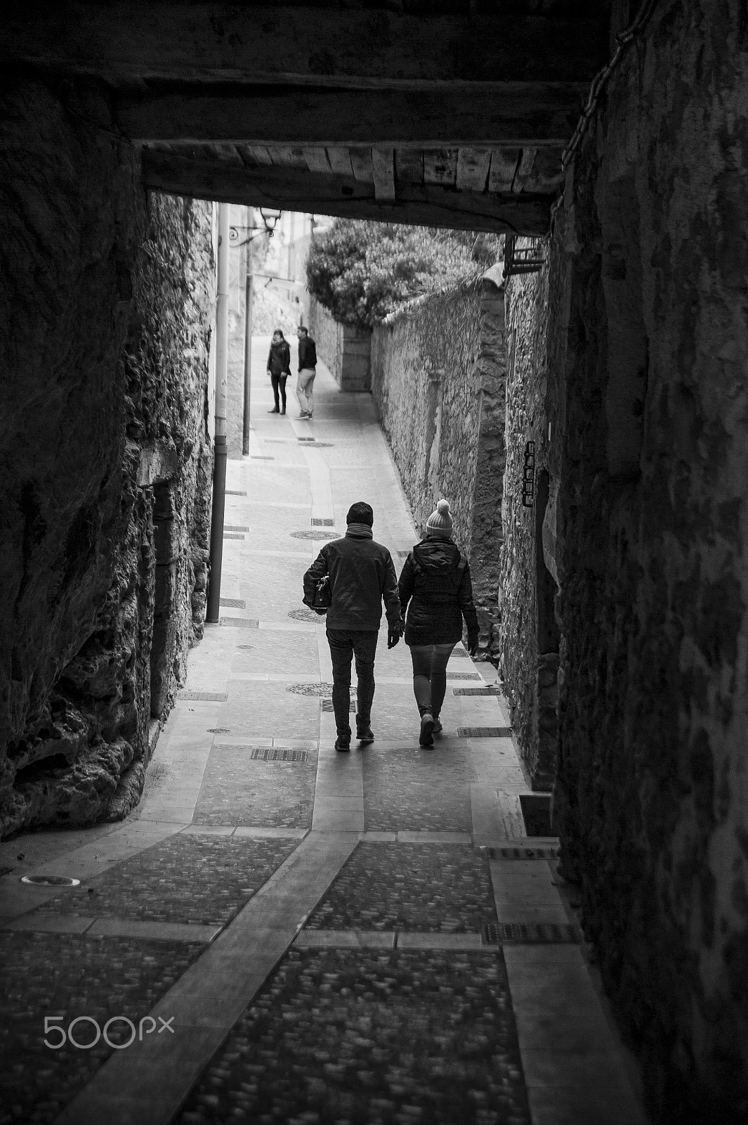 Nikon D700 + Tamron SP 24-70mm F2.8 Di VC USD sample photo. People crossing an old urban stone-walled passage photography