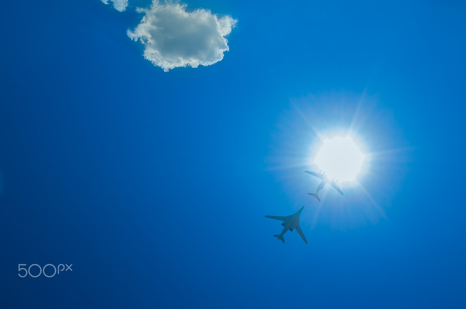 smc PENTAX-DA L 18-55mm F3.5-5.6 sample photo. Two bombers fly up through the sun photography