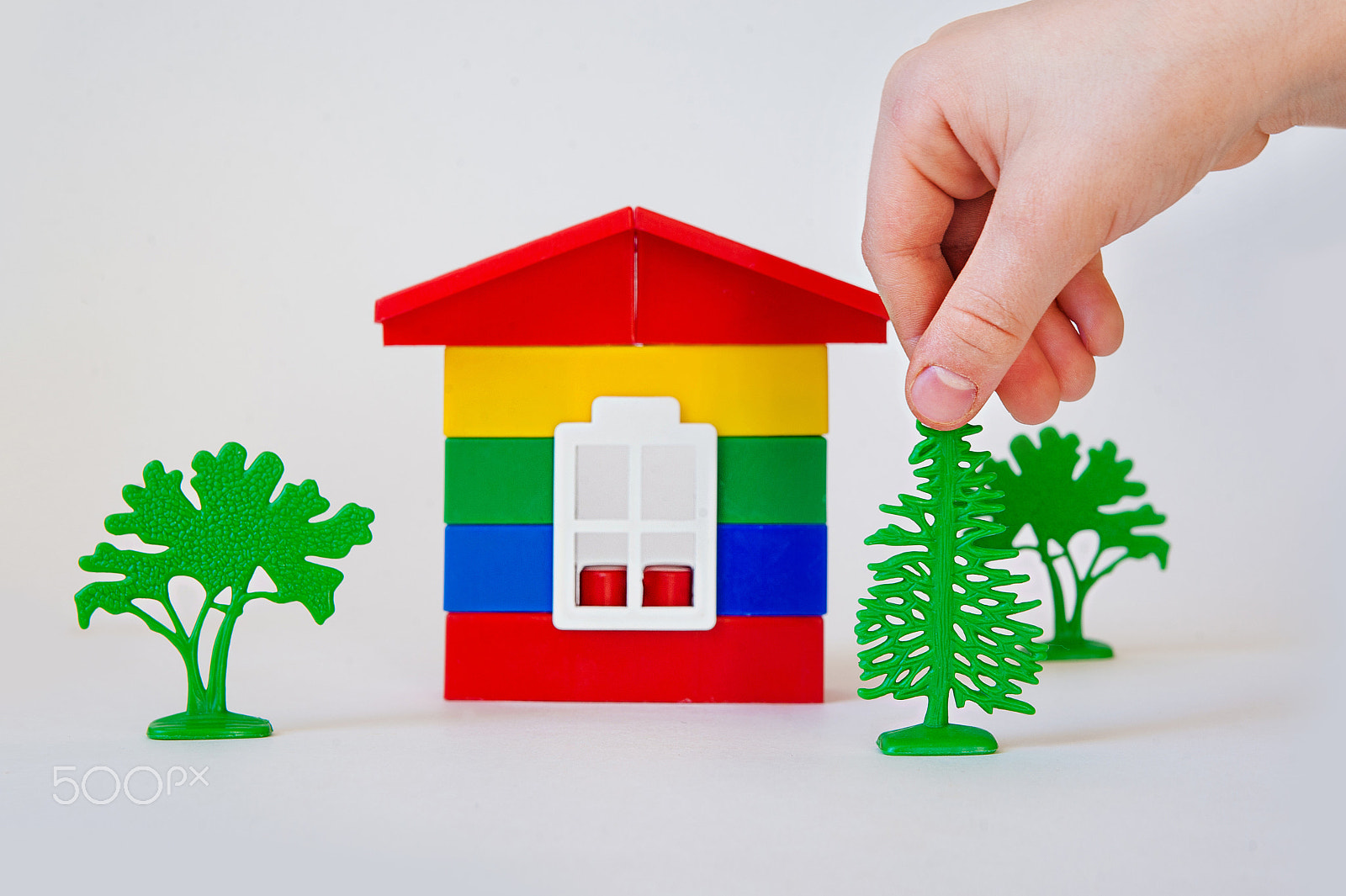 Nikon D700 + Sigma 24-70mm F2.8 EX DG Macro sample photo. Children's hand in building a dream home of colored bricks photography