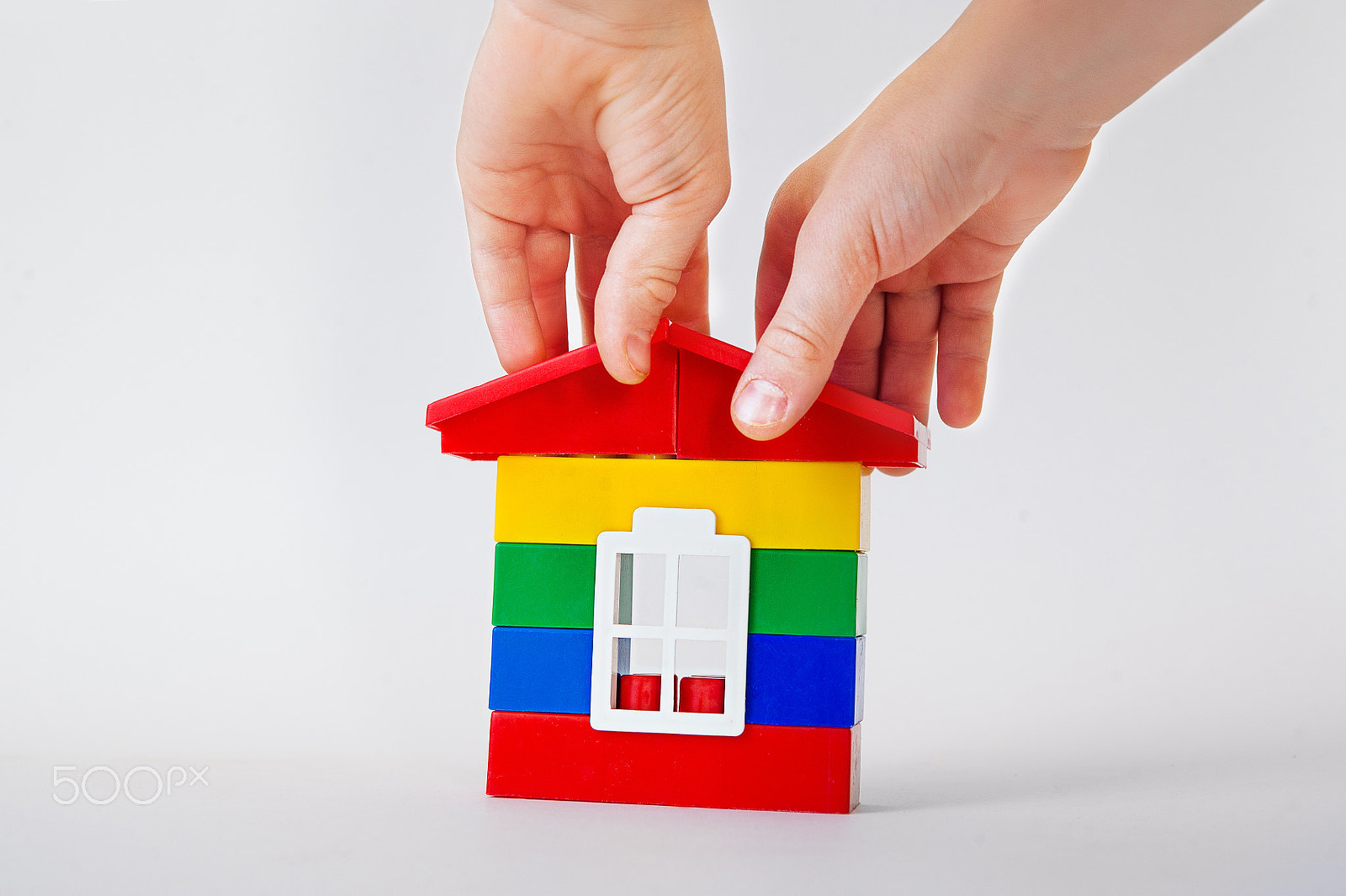 Nikon D700 + Sigma 24-70mm F2.8 EX DG Macro sample photo. Hand putting a roof to make up a house on white background. building concept. bank loans. mortgage photography