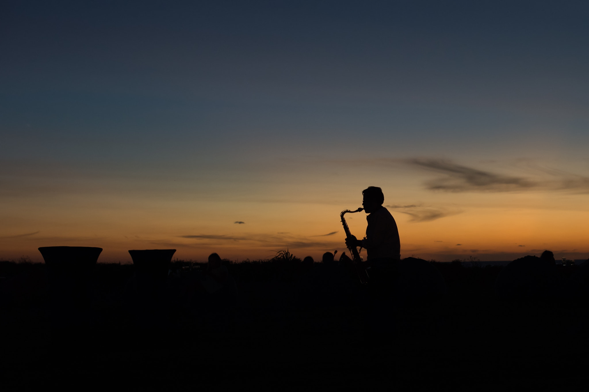 Nikon Df sample photo. Man playing music under sunset photography