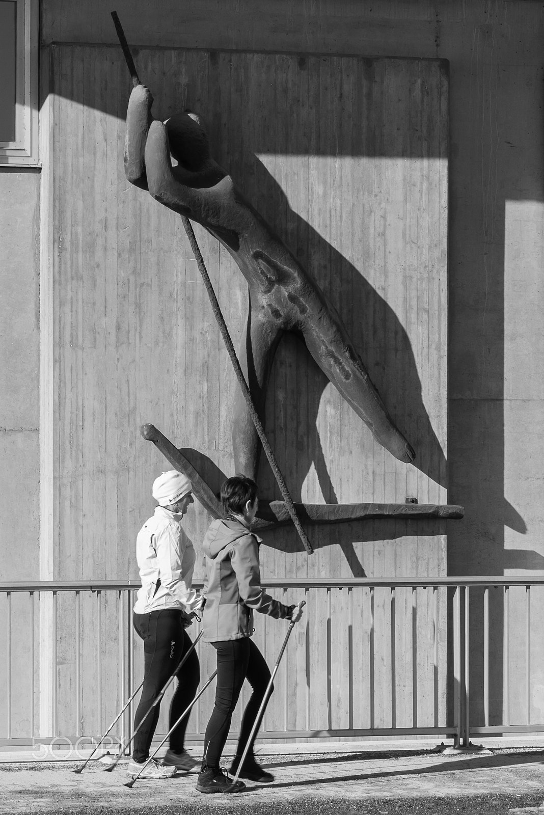 Nikon D800 + Sigma 24-70mm F2.8 EX DG HSM sample photo. Street photograpy of nordic walker under a ferryma photography