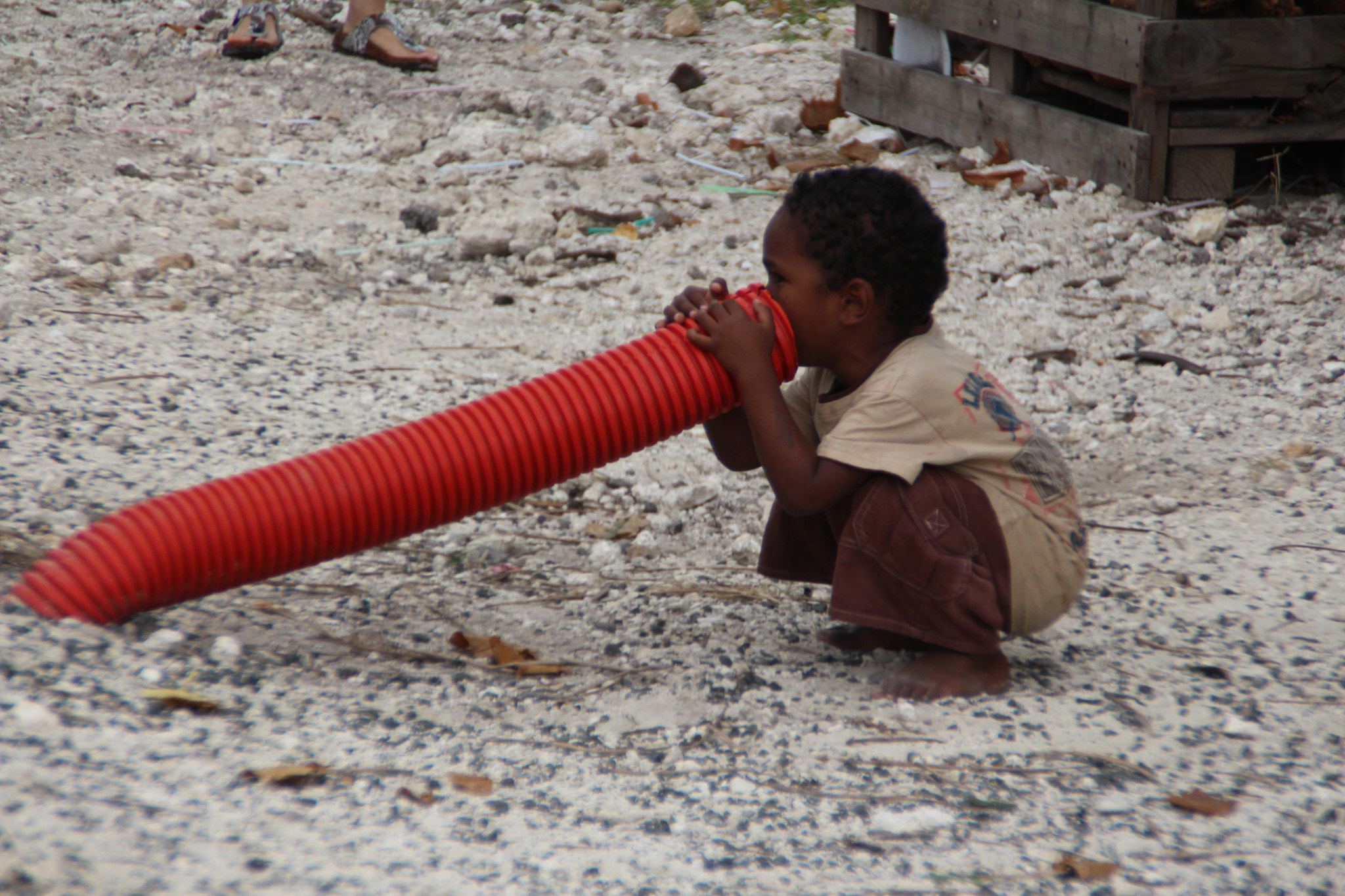 Canon EOS 650D (EOS Rebel T4i / EOS Kiss X6i) + Tamron AF 18-200mm F3.5-6.3 XR Di II LD Aspherical (IF) Macro sample photo. Little boy talking down a road pipe in lifou island new caledonia photography