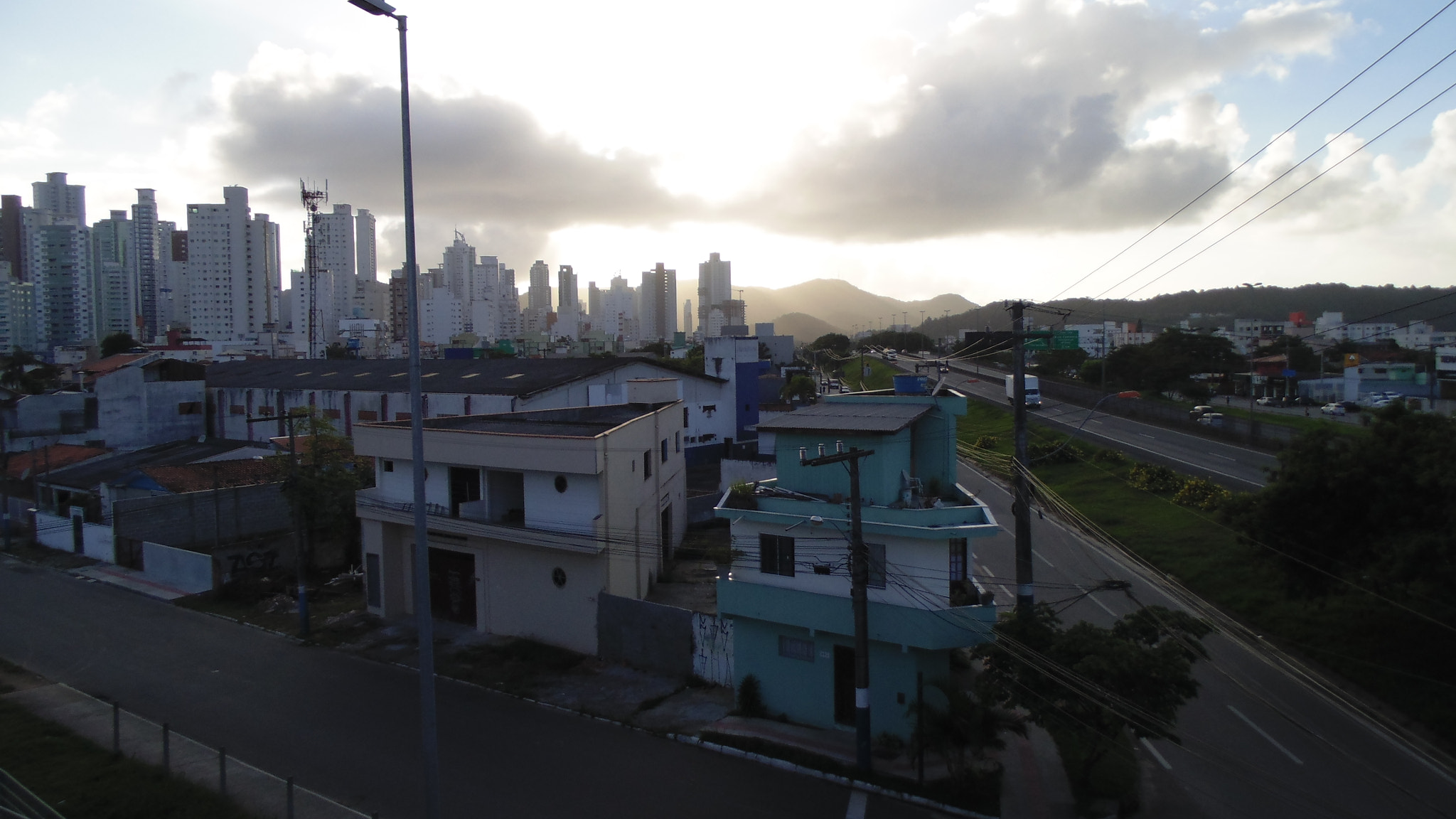 Sony DSC-H100 sample photo. The sunrise behind the great wall of buildings photography