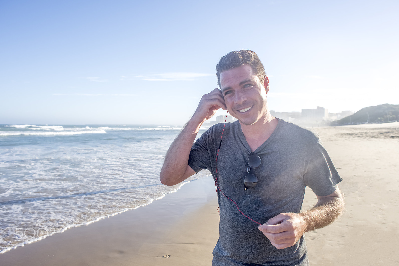 Nikon D600 + Nikon AF Nikkor 24mm F2.8D sample photo. Man on beach with earphones photography