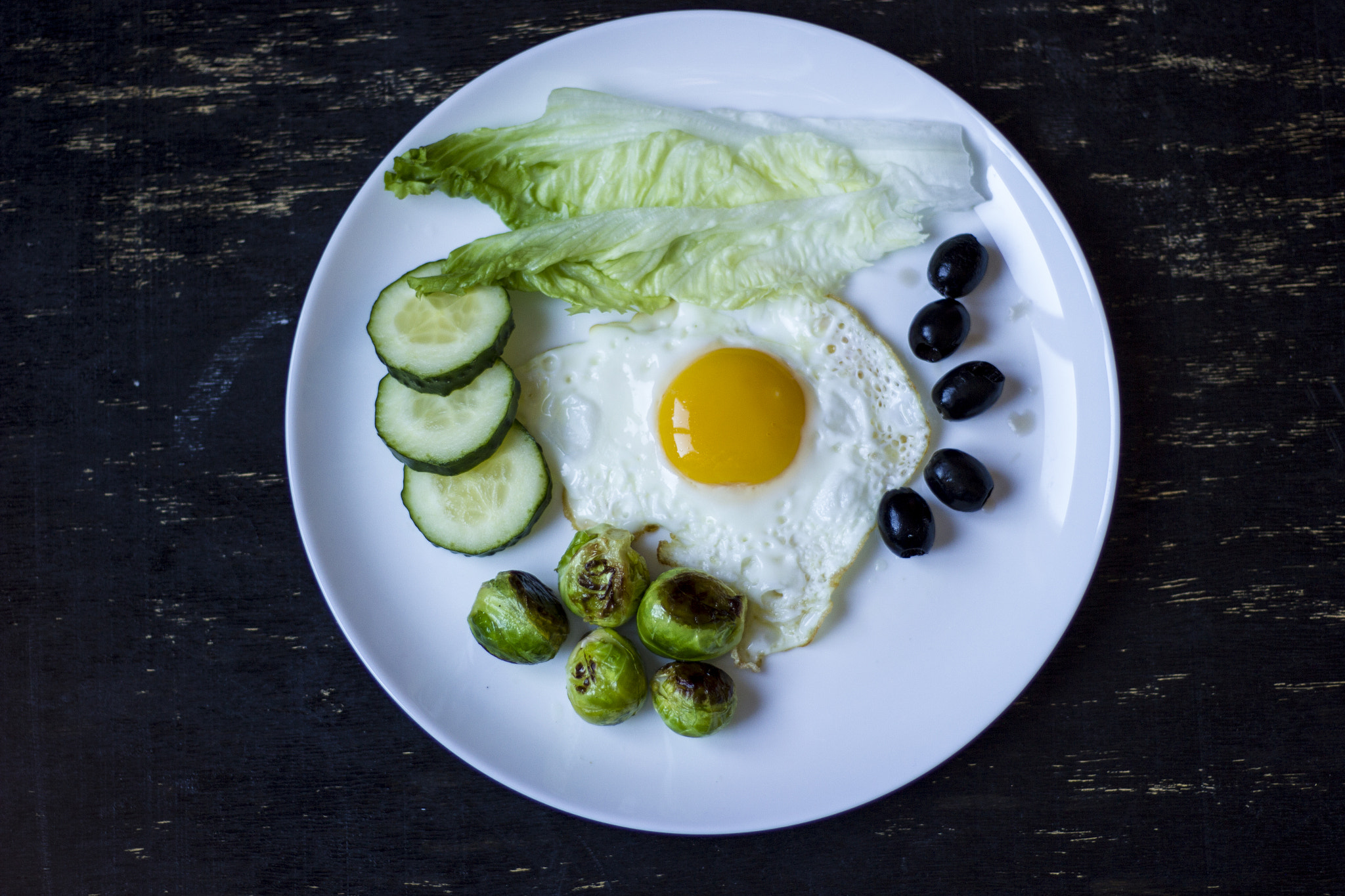 Canon EOS 550D (EOS Rebel T2i / EOS Kiss X4) sample photo. Fried egg with cucumbers, olives, and brussels spr photography