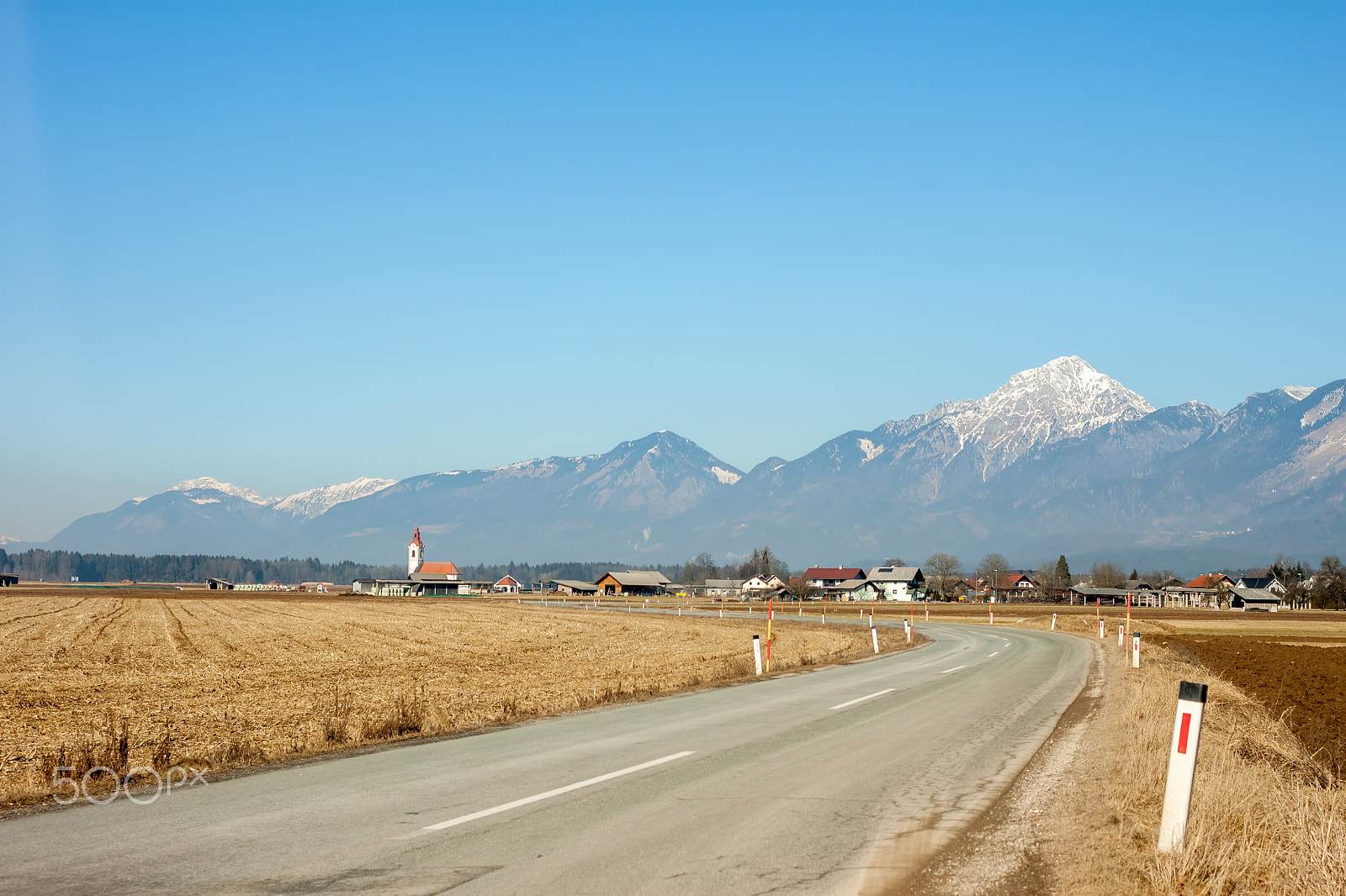 Canon EOS 500D (EOS Rebel T1i / EOS Kiss X3) + Canon EF 40mm F2.8 STM sample photo. Picturesque road among fields and mountains photography