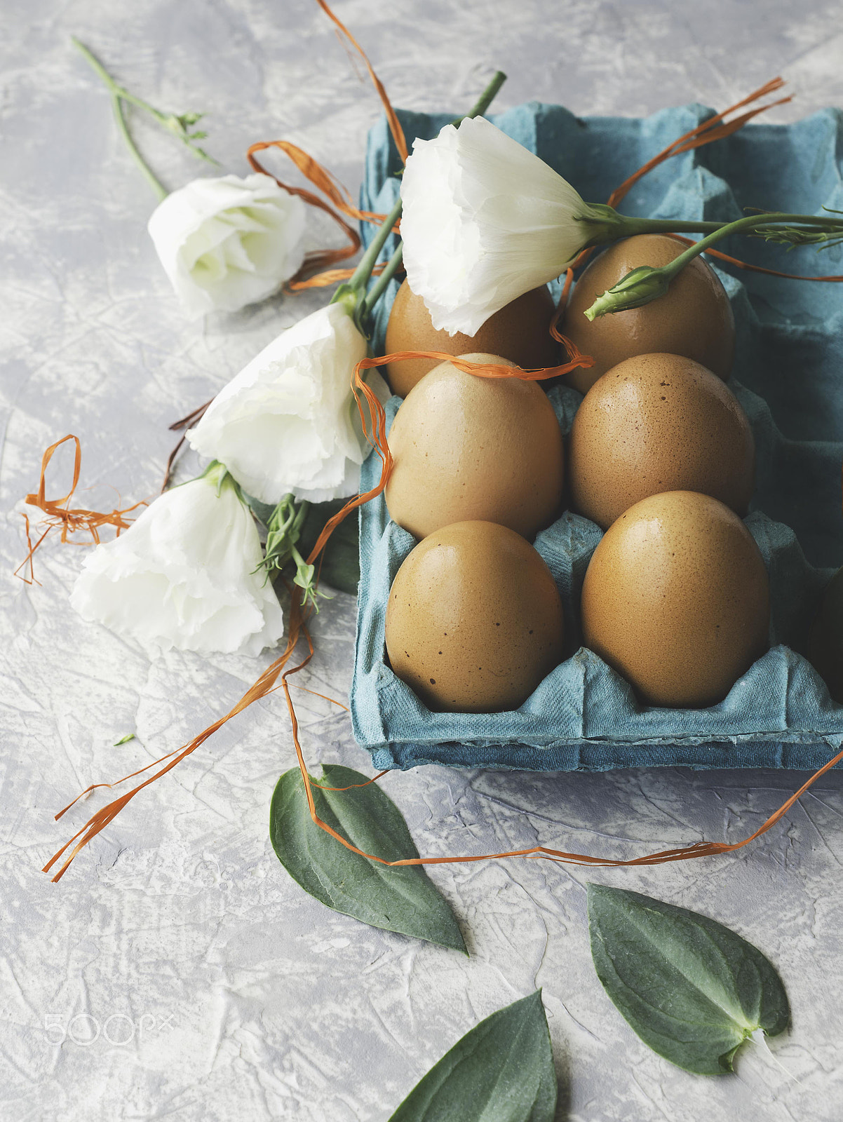 Nikon AF-S DX Micro Nikkor 40mm F2.8 sample photo. Raw eggs in a carton for eggs with white flowers on a marble white table, ready for painting... photography