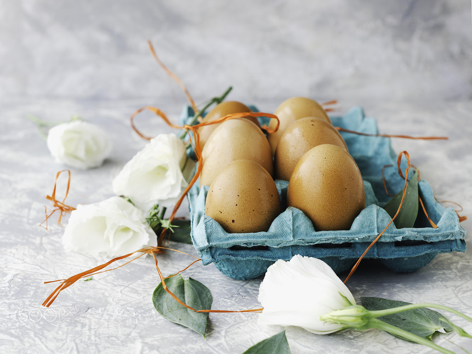 Nikon AF-S DX Micro Nikkor 40mm F2.8 sample photo. Raw eggs in a carton for eggs with white flowers on a marble white table, ready for painting... photography