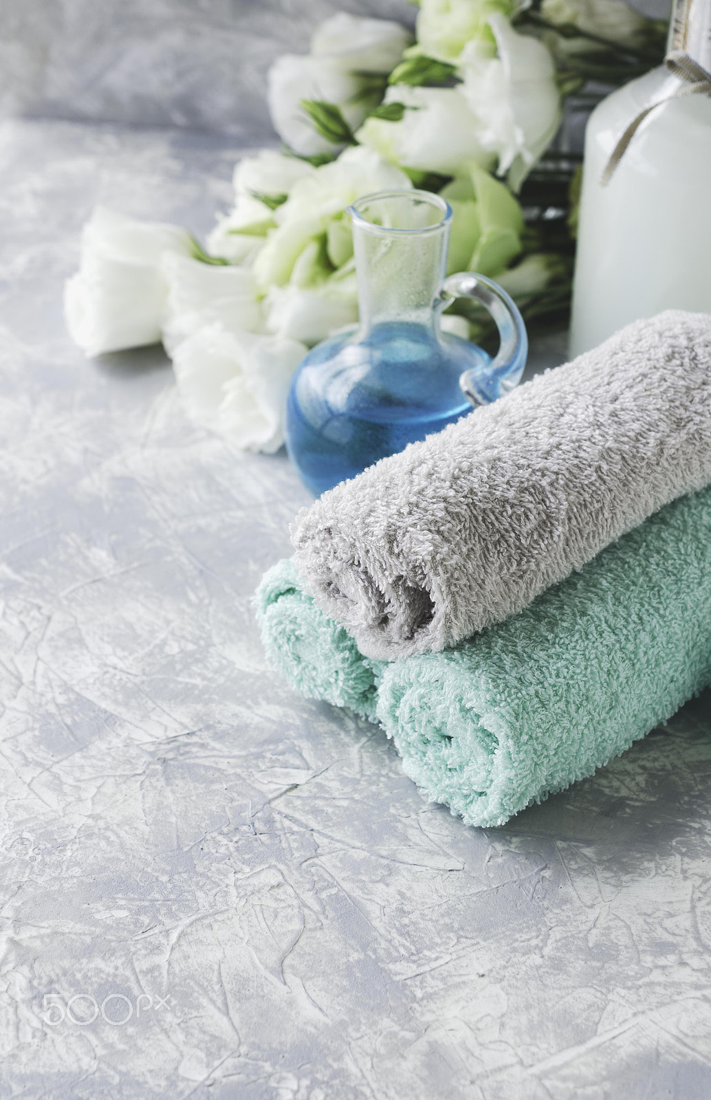 Nikon AF-S DX Micro Nikkor 40mm F2.8 sample photo. Spa set on a white marble table with a stack of towels, selective focus photography