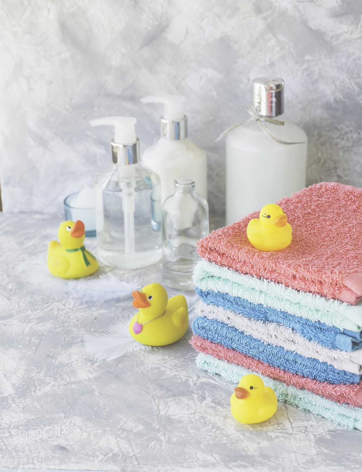Nikon D7000 + Nikon AF-S DX Micro Nikkor 40mm F2.8 sample photo. Stack of towels with yellow rubber bath ducks on white marble background, space for text,... photography