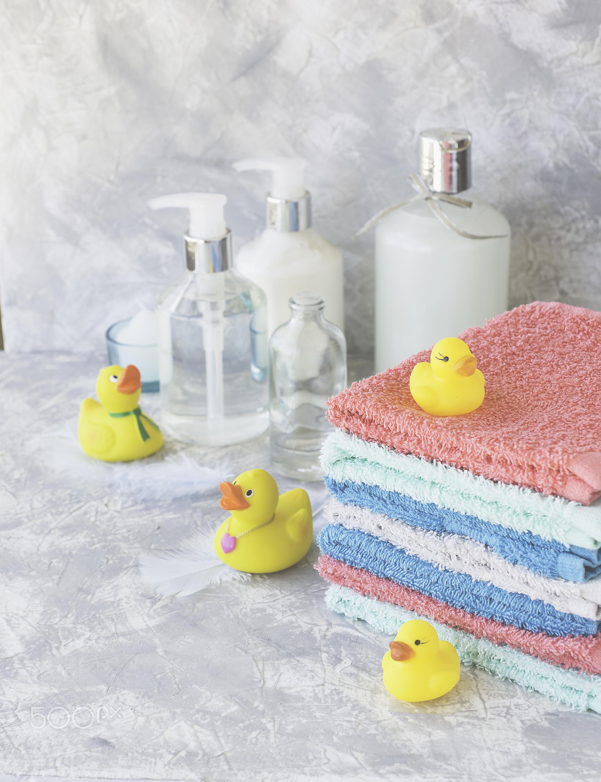 Nikon AF-S DX Micro Nikkor 40mm F2.8 sample photo. Stack of towels with yellow rubber bath ducks on white marble background, space for text,... photography