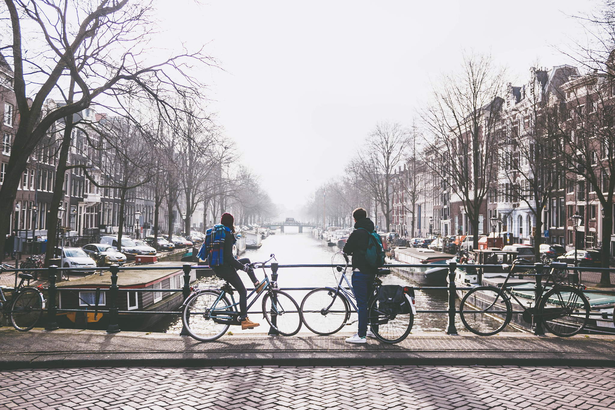 Canon EOS 650D (EOS Rebel T4i / EOS Kiss X6i) sample photo. A couple in amsterdam stop to take in the never ending canal sights. photography