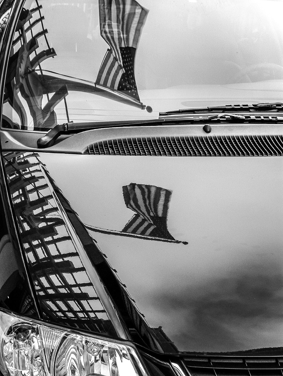 Nikon E5000 sample photo. Flag double reflection on a car photography