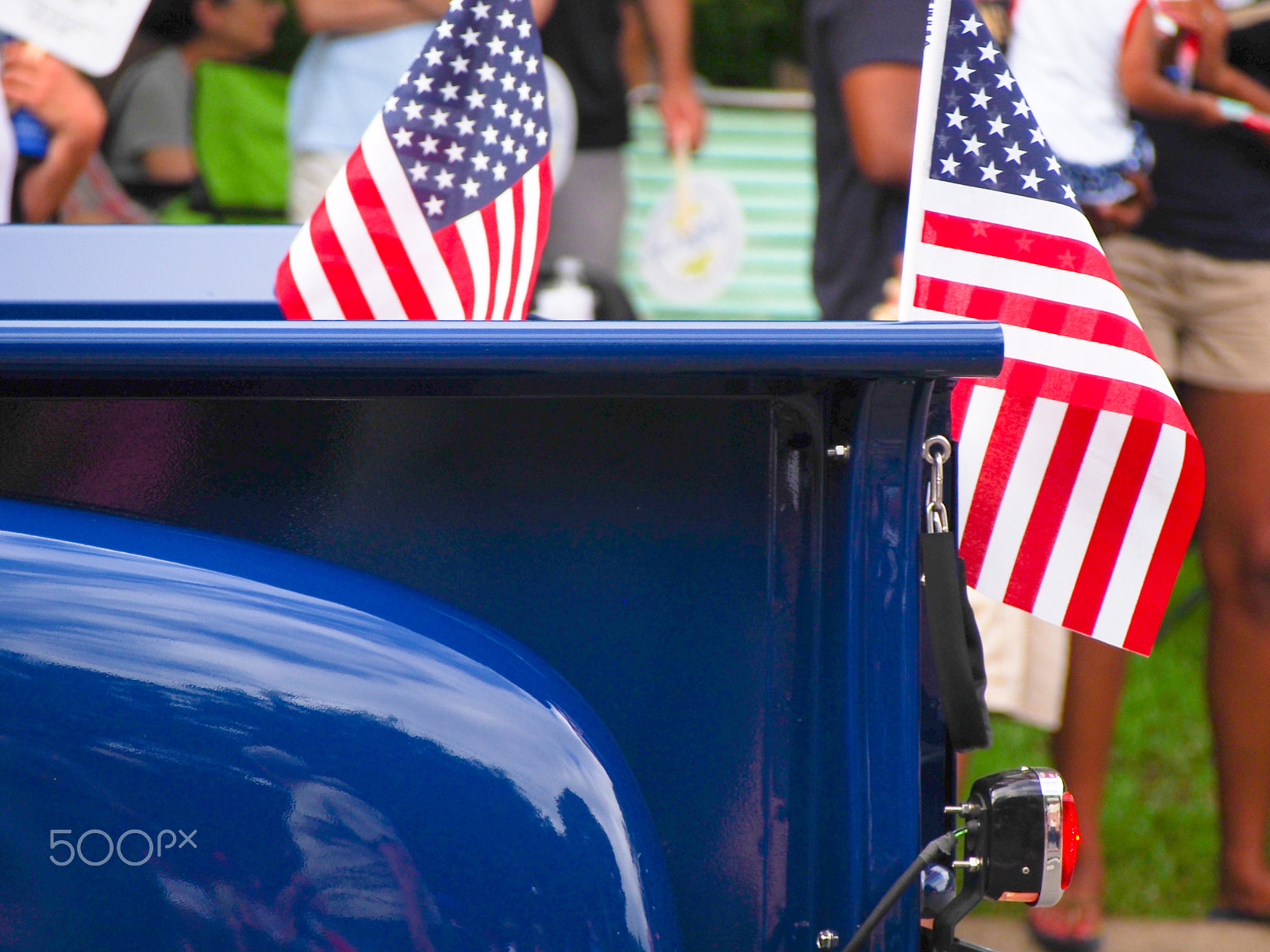 Olympus OM-D E-M5 sample photo. American flags on bright blue classic pickup truck in fourth of july parade photography