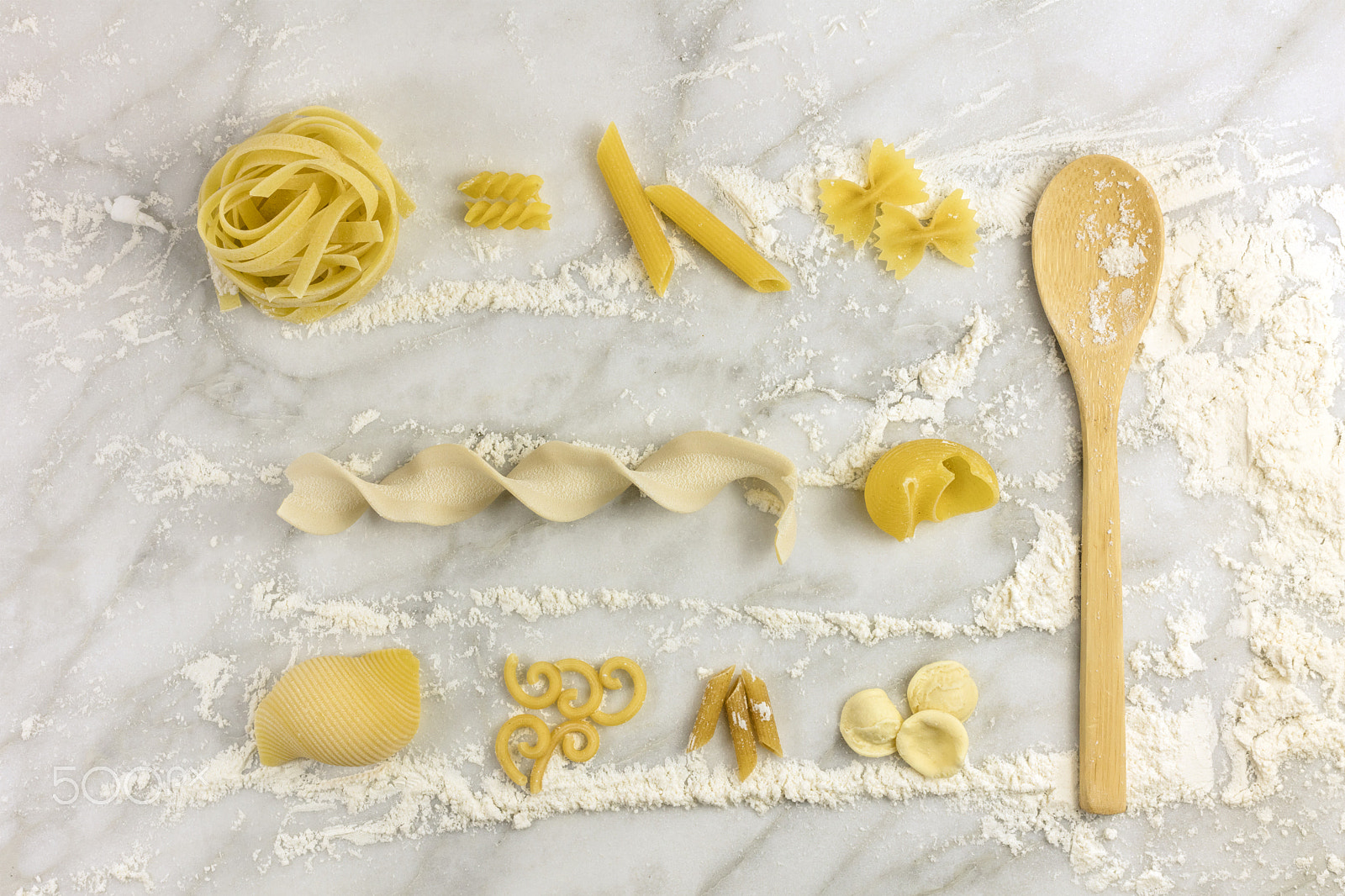 Canon EOS 5DS R + Canon EF 50mm F1.4 USM sample photo. Various types of pasta on white marble table with flour photography