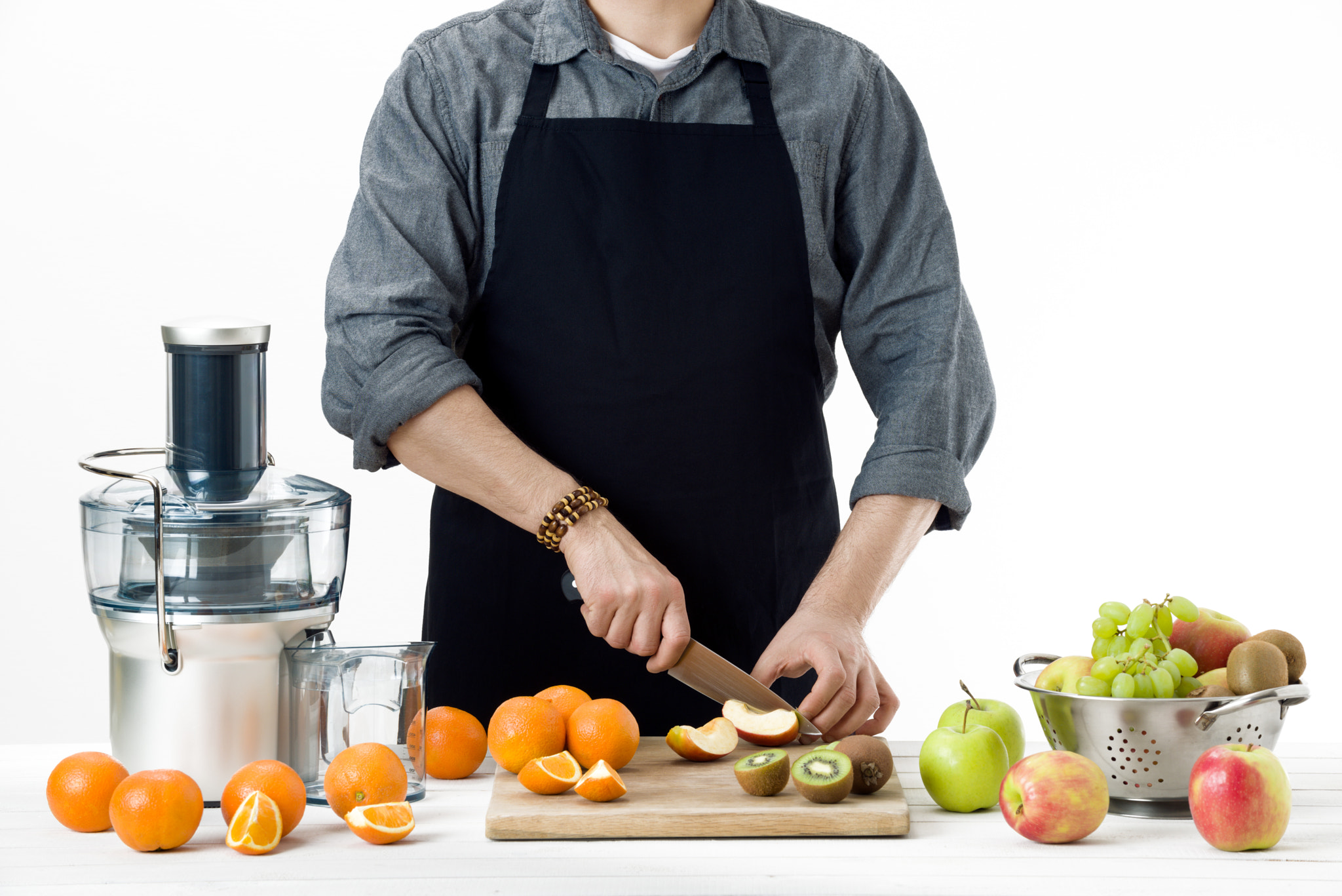 Nikon D810 sample photo. Anonymous man wearing an apron, preparing healthy freshly made fruit juice, using modern electric... photography